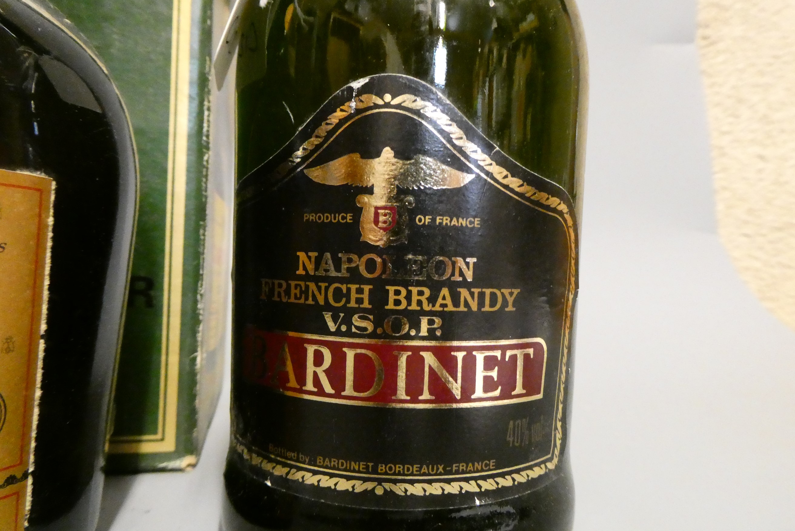 Three bottles, comprising a boxed Courvoisier VSOP cognac, a Bardinet Napoleon VSOP French Brandy, Image