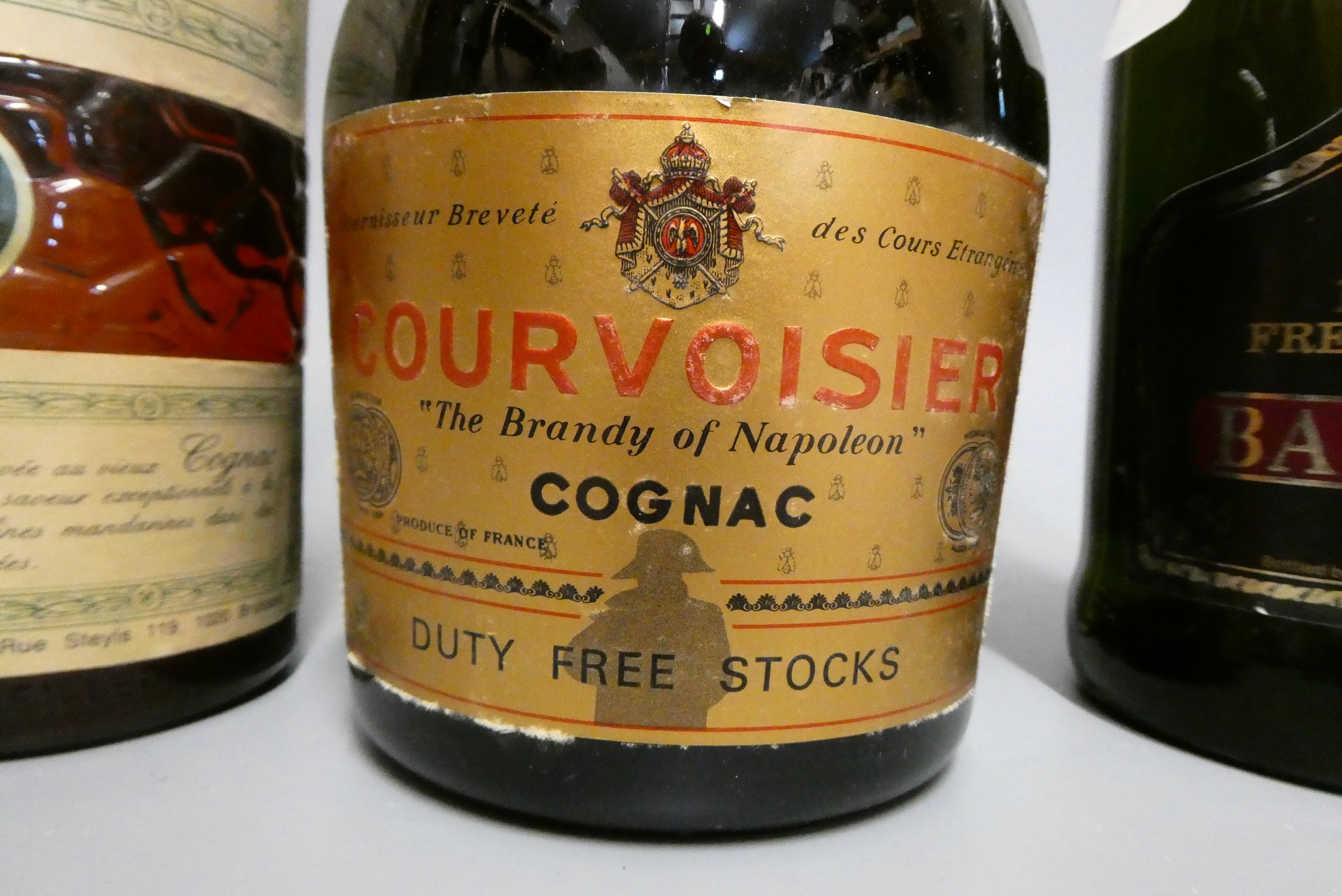 Three bottles, comprising a boxed Courvoisier VSOP cognac, a Bardinet Napoleon VSOP French Brandy, Image