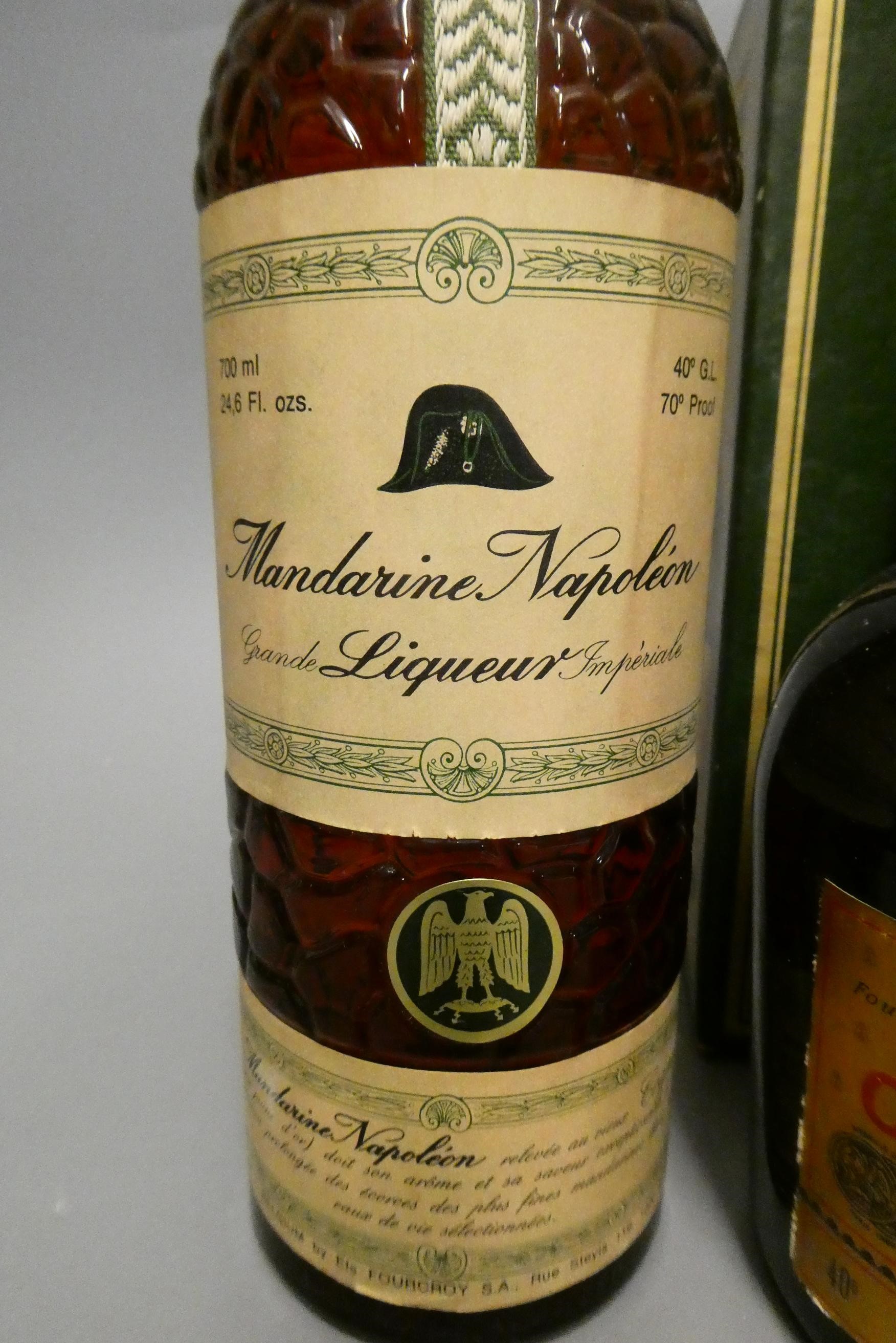 Three bottles, comprising a boxed Courvoisier VSOP cognac, a Bardinet Napoleon VSOP French Brandy, Image