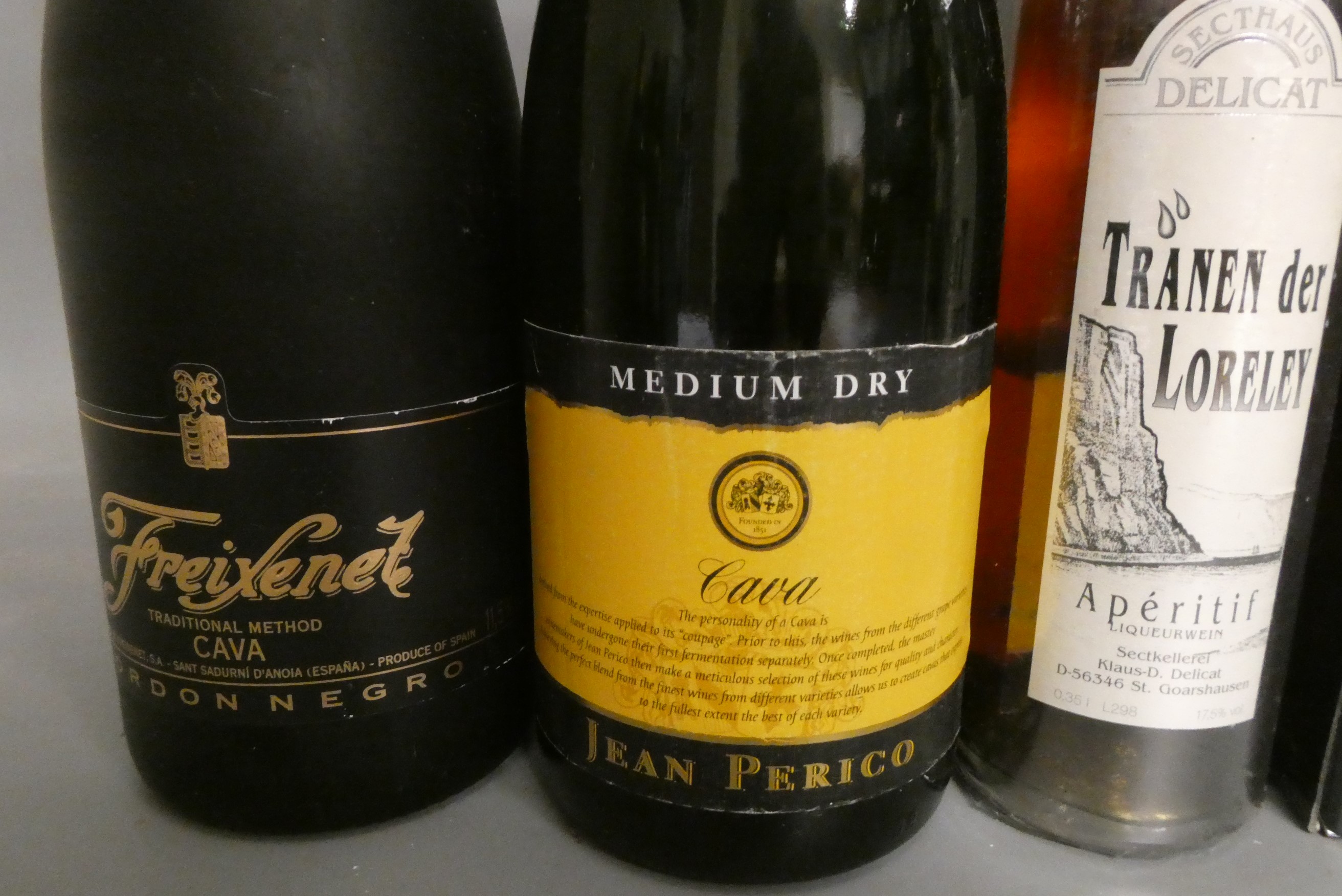 Nine bottles of champagne and mixed alcohol Image