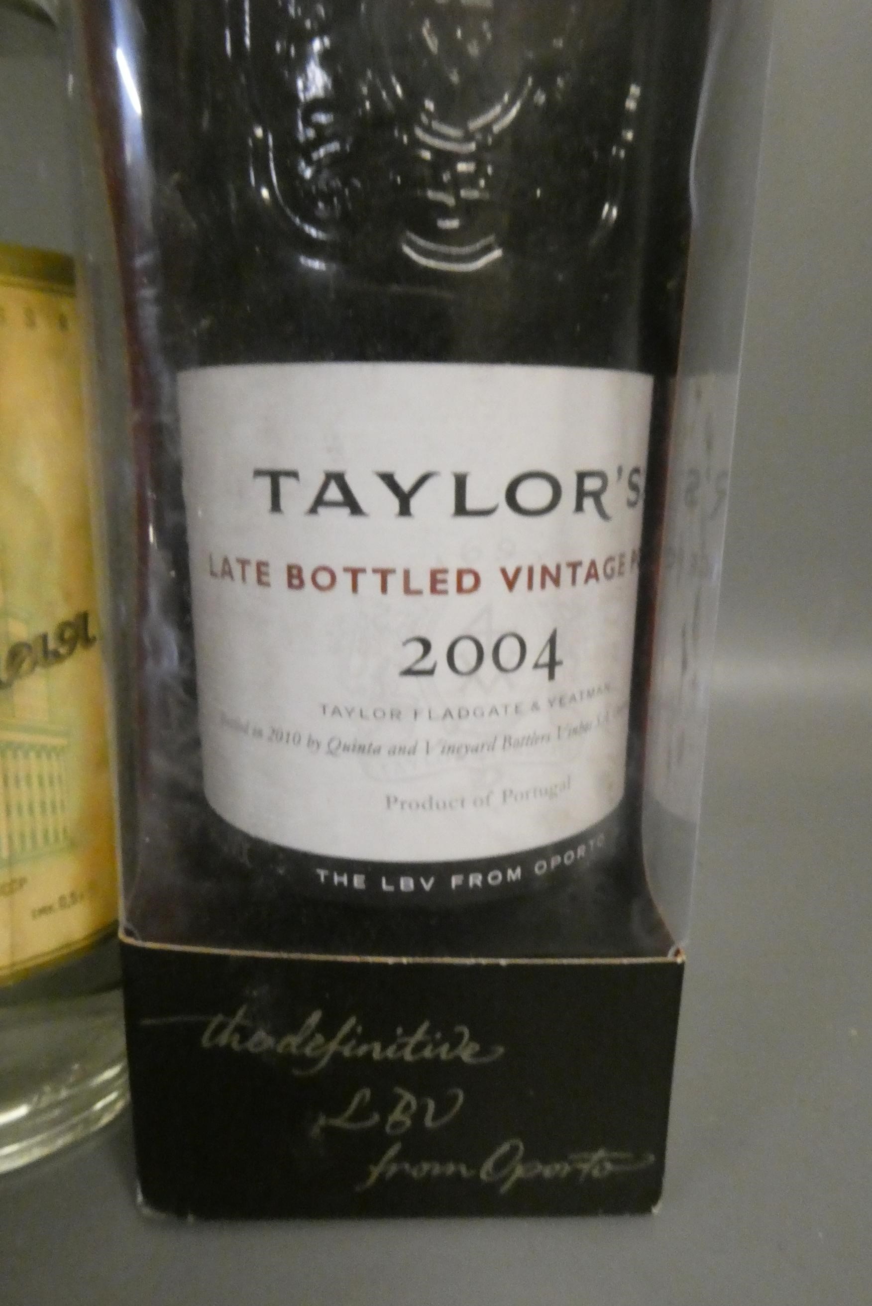 Four bottles of mixed alcohol, comprising a boxed Taylor's 2004 LBV port, a bottle of USSR vodka, a Image