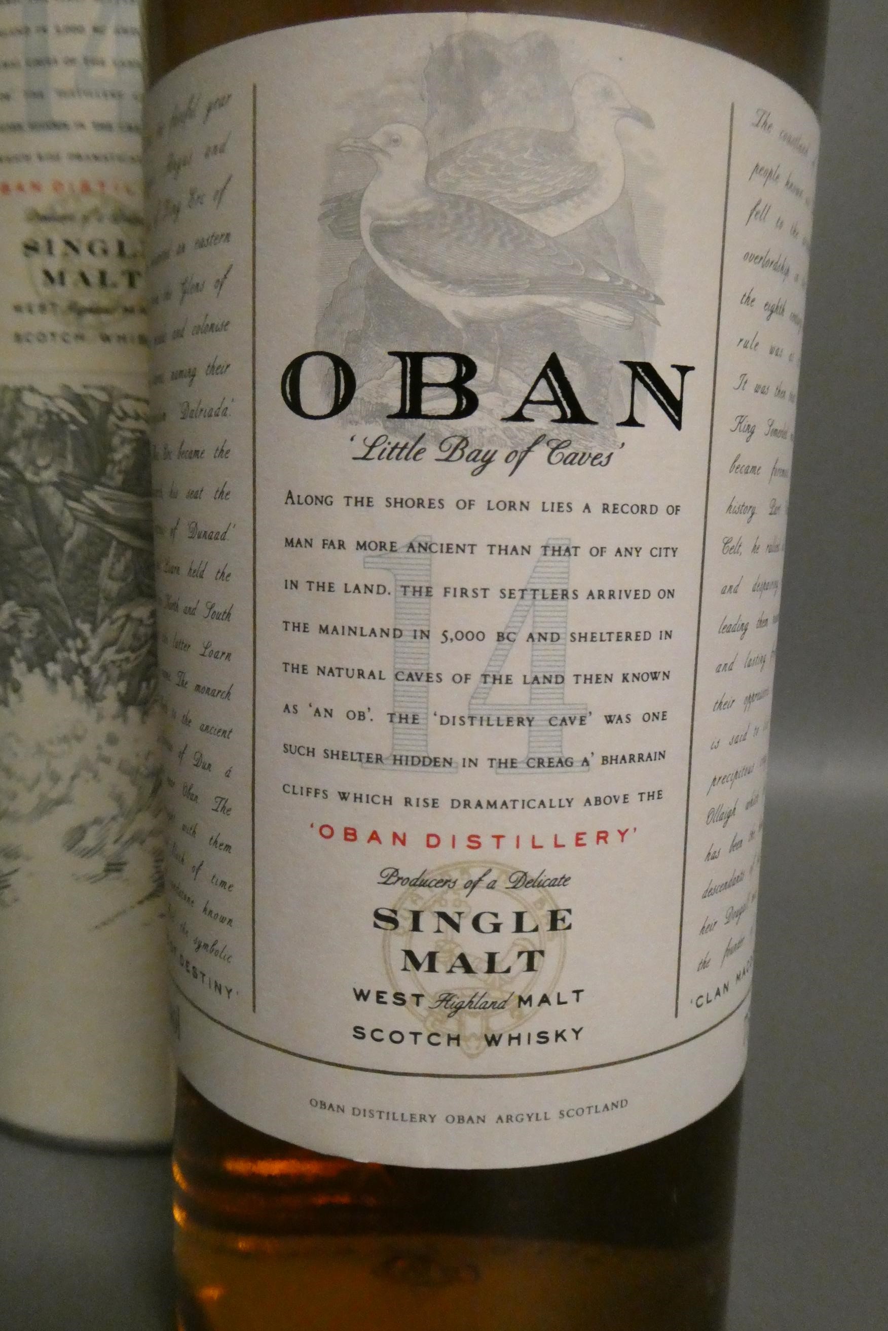 One bottle of Oban 14yr old West Highland single malt whisky, with tube, together with a Tobermory Image