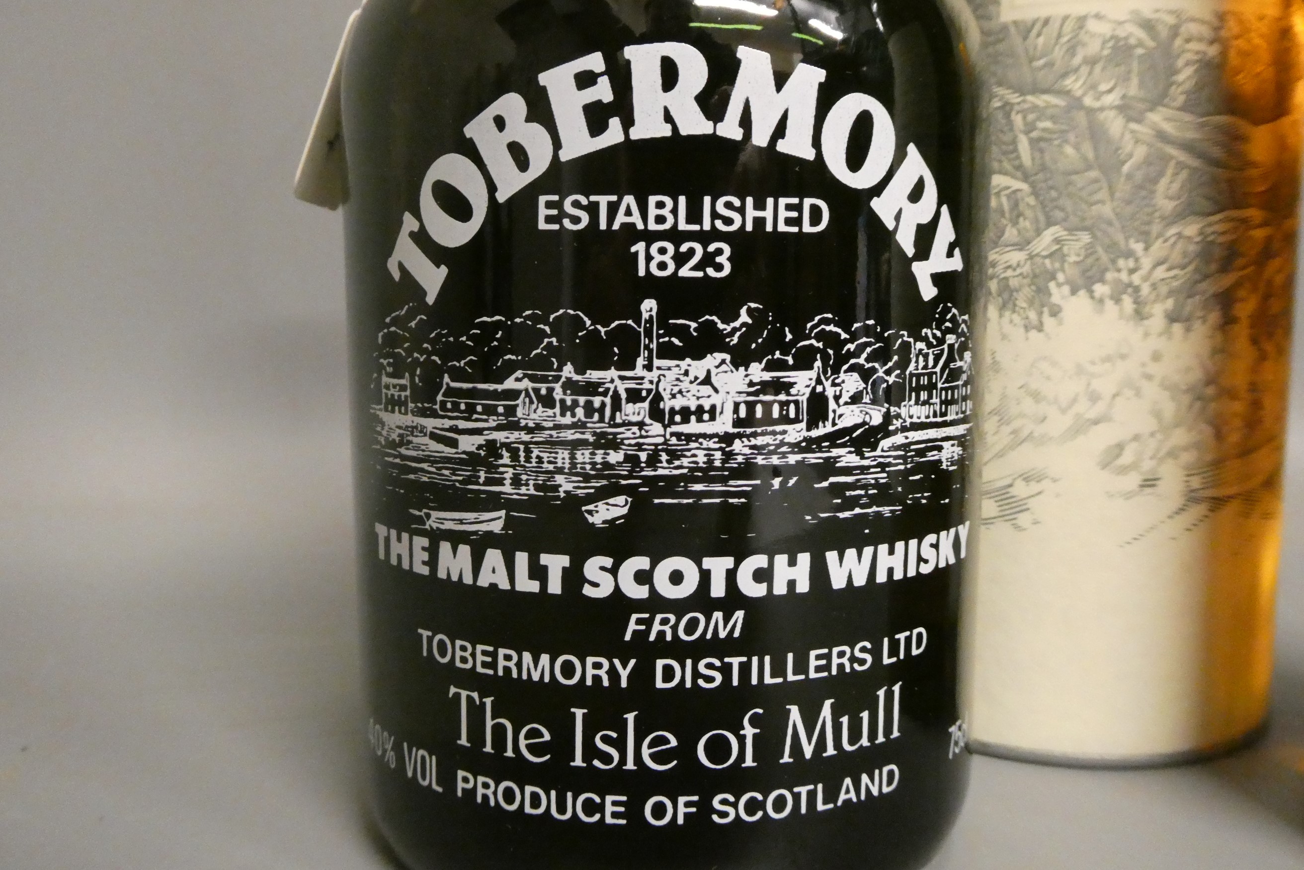 One bottle of Oban 14yr old West Highland single malt whisky, with tube, together with a Tobermory Image