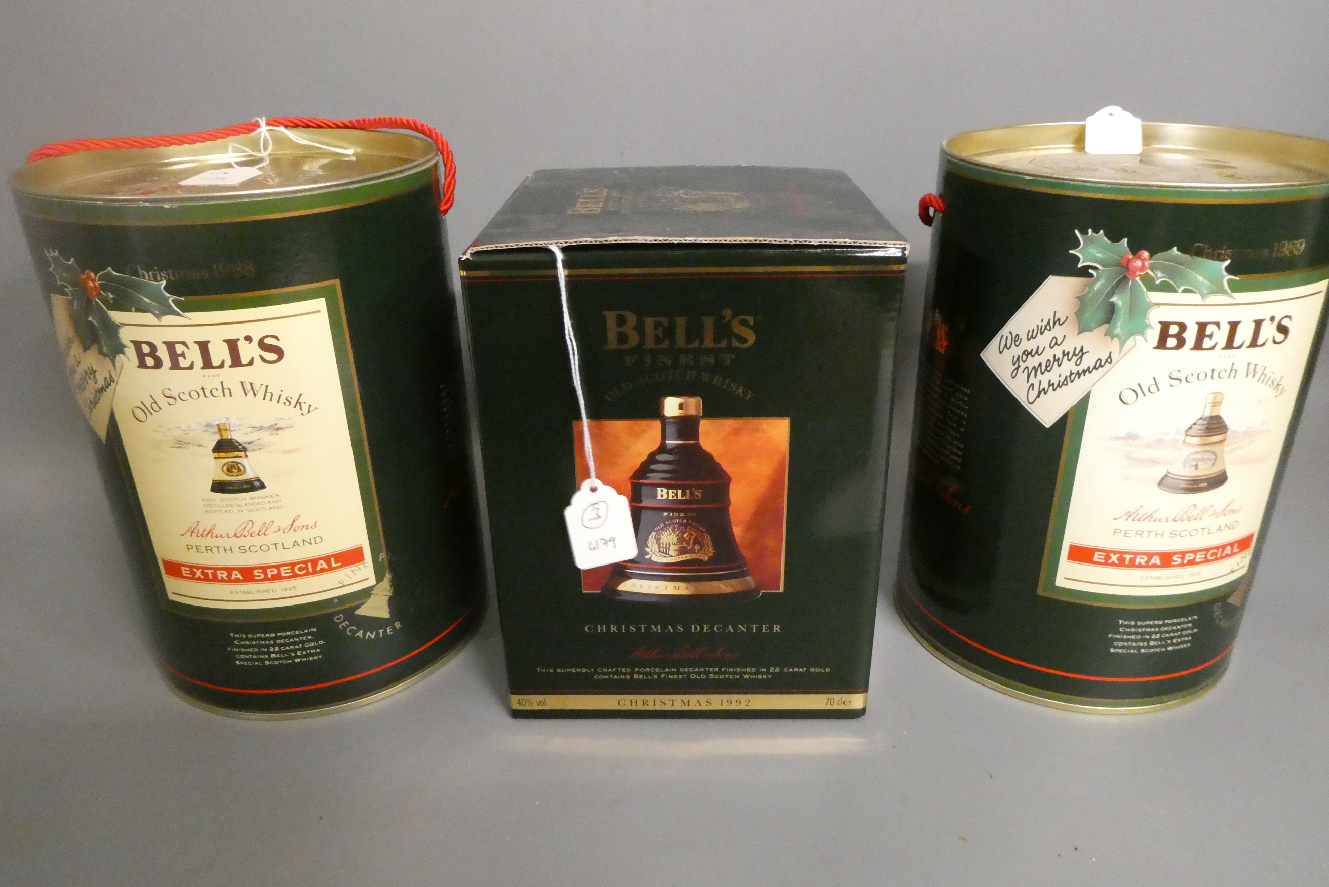 Three Bell's christmas whisky decanters, comprising two 75cl decanters for 1988 and 1989 in tubs, Image