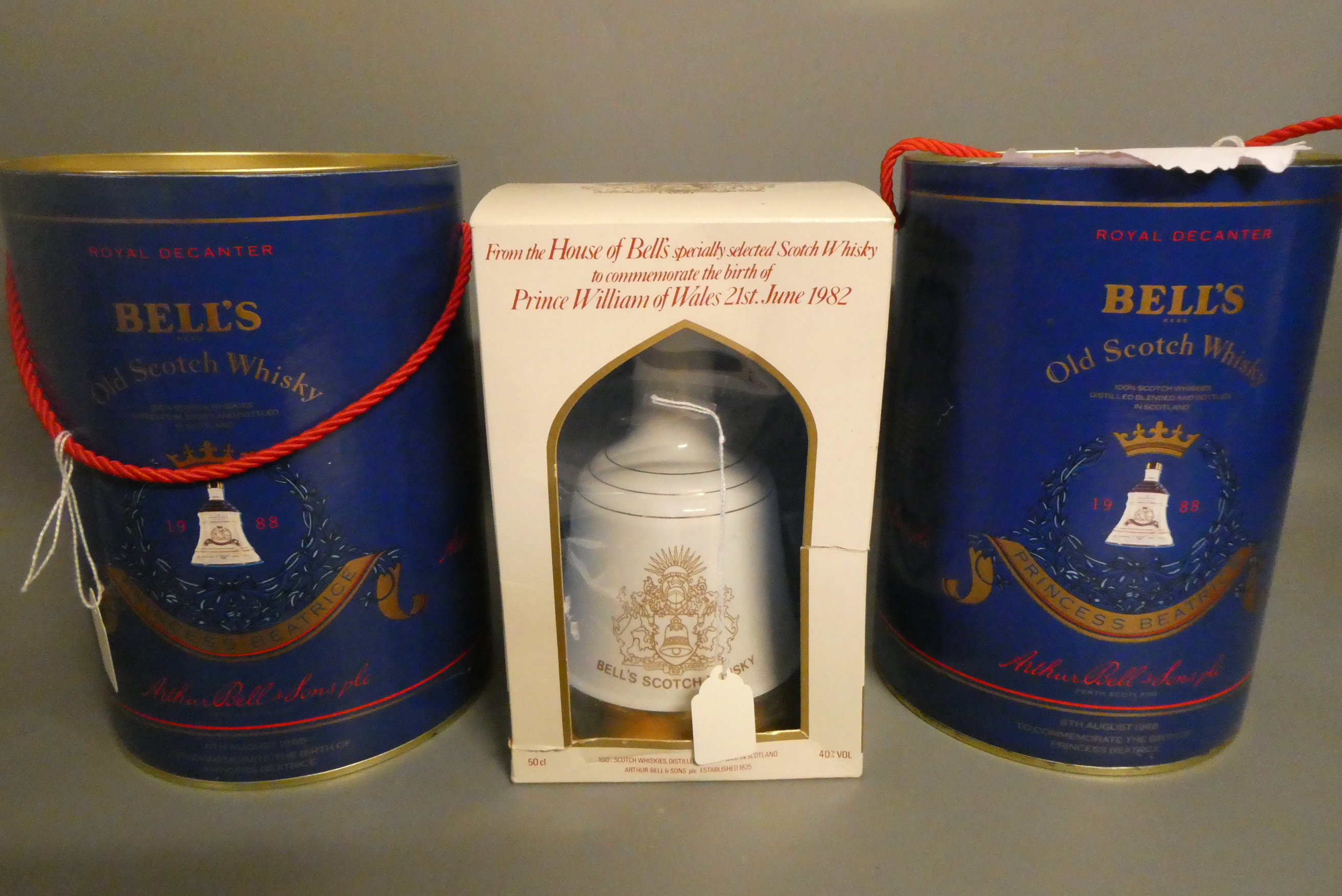 Three Bell's whisky decanters, comprising two Princes Beatrice 75cl decanters in tubs and a boxed Image