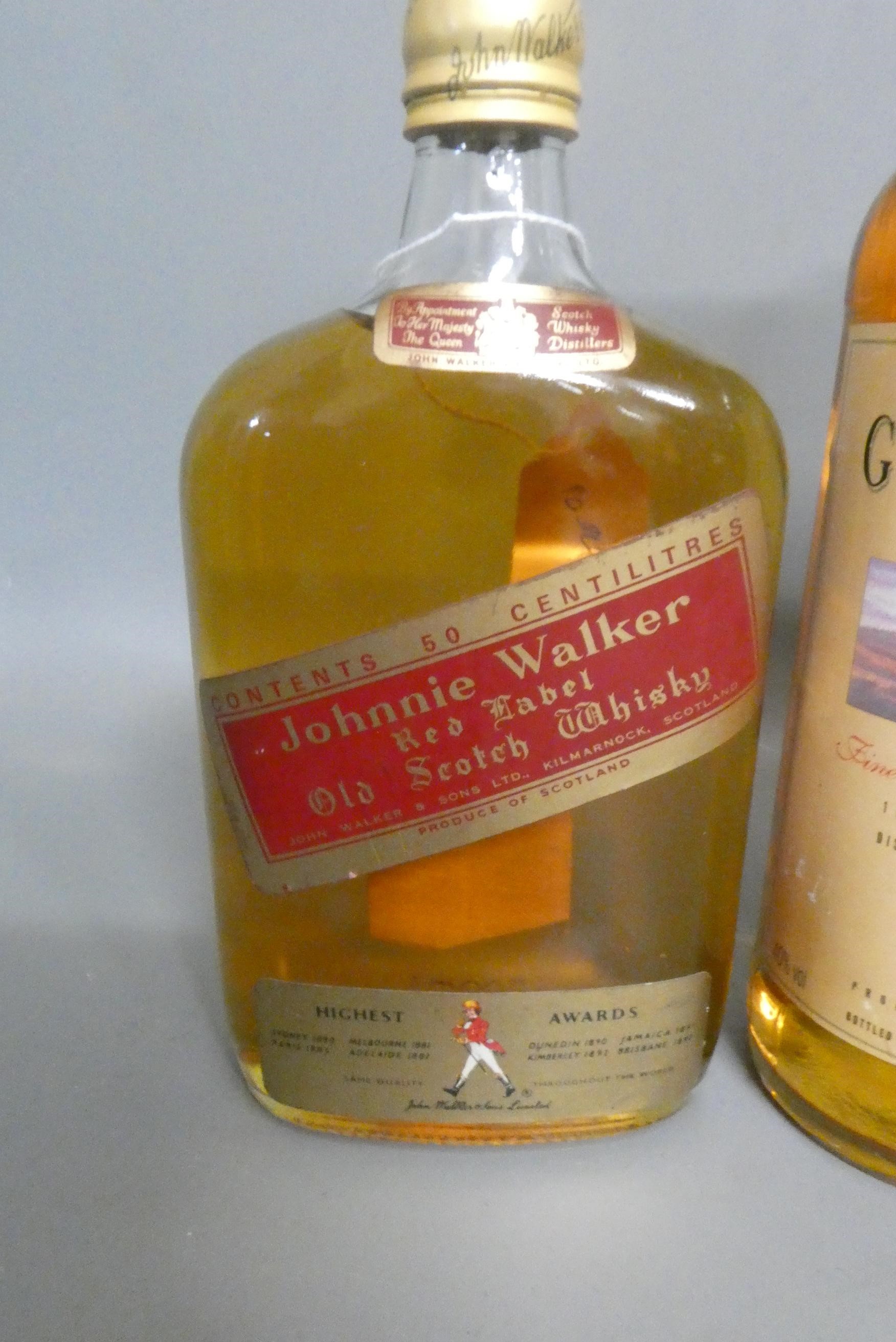 Four bottles of whisky, comprising 1litre Johnnie Walker Black Label, a 500ml Johnnie Walker Red Image