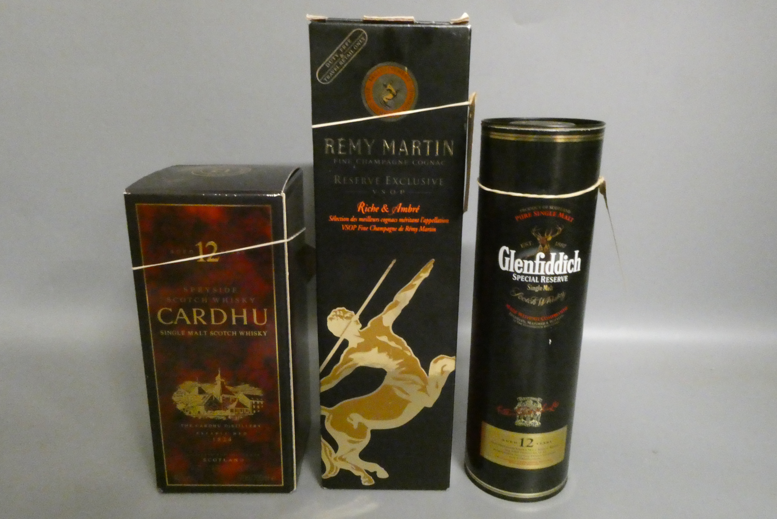 Two bottles of whisky and a cognac Image