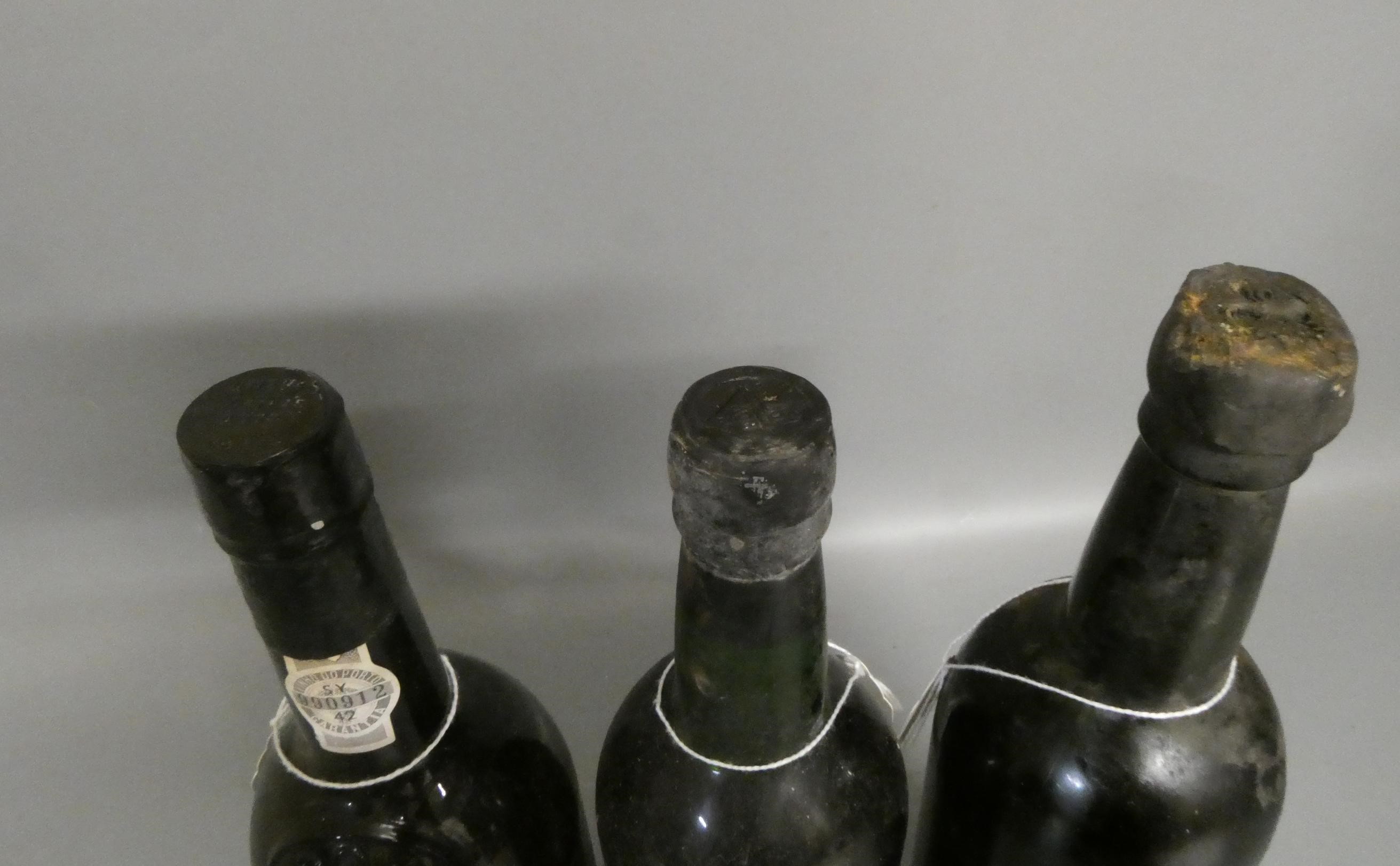 Three bottles Dow's vintage port, comprising one 1970, one 1977 and another that is purporting to be Image