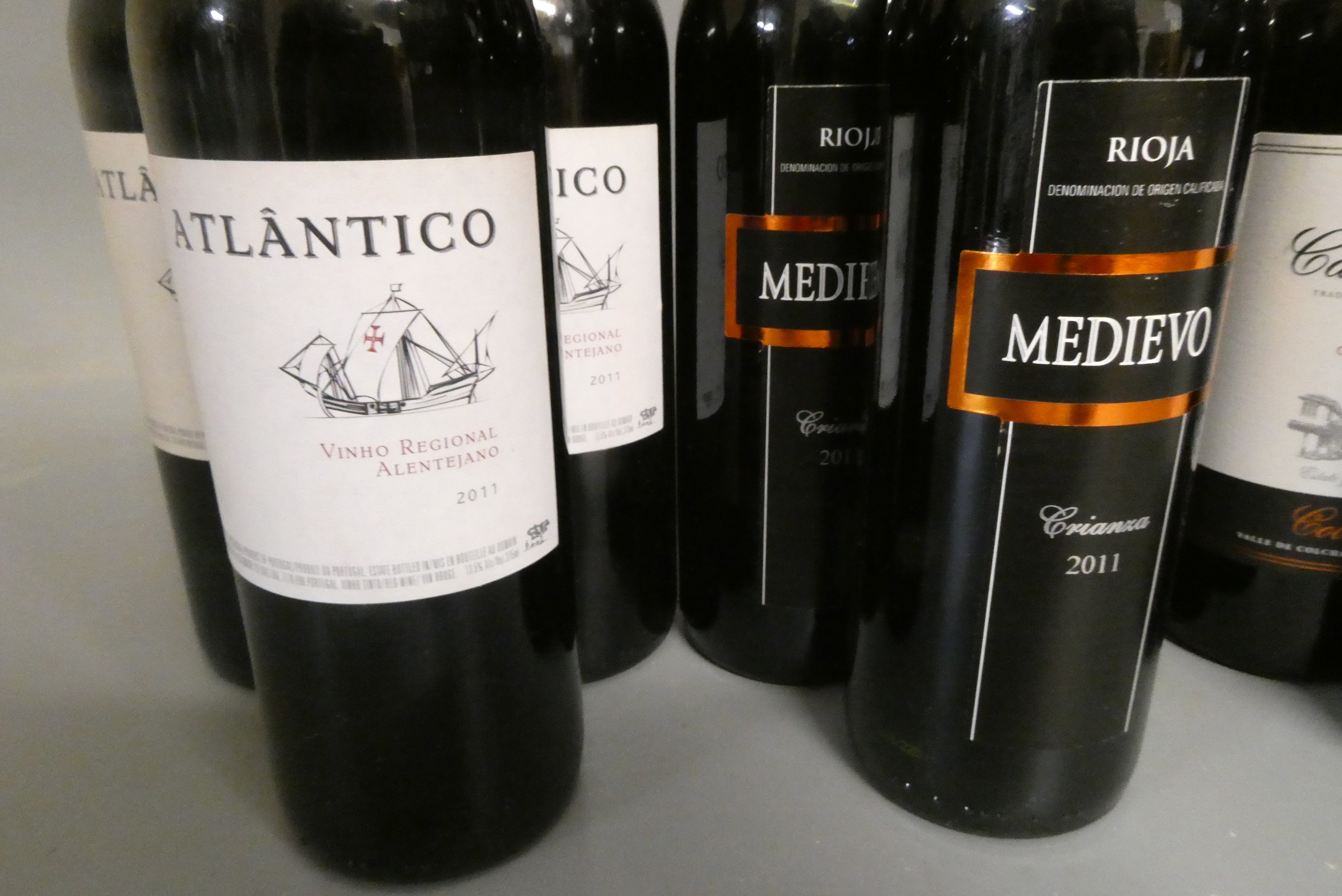 Twelve half and one full bottle of European red wine Image