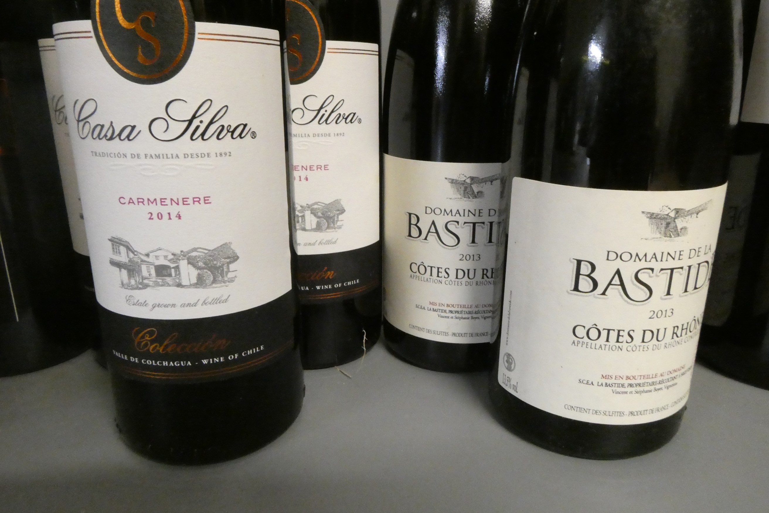 Twelve half and one full bottle of European red wine Image