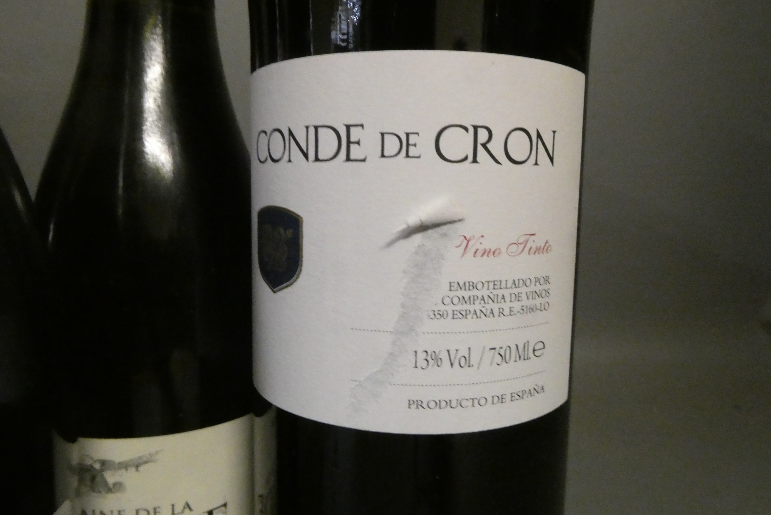 Twelve half and one full bottle of European red wine Image