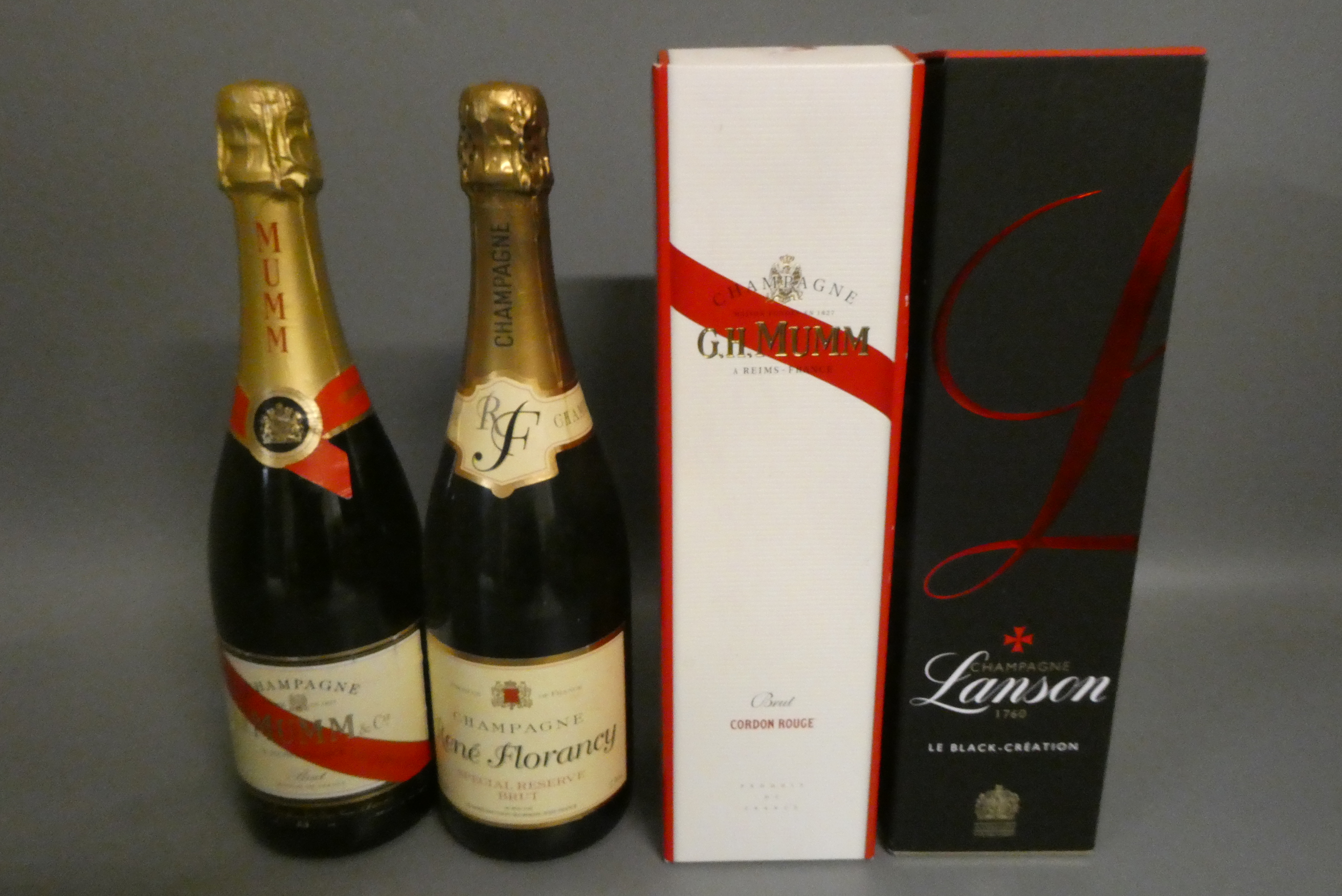 Four bottles of champagne comprising a boxed Lanson Le Black, two Mumm Cordon Rouge (one boxed) and Image