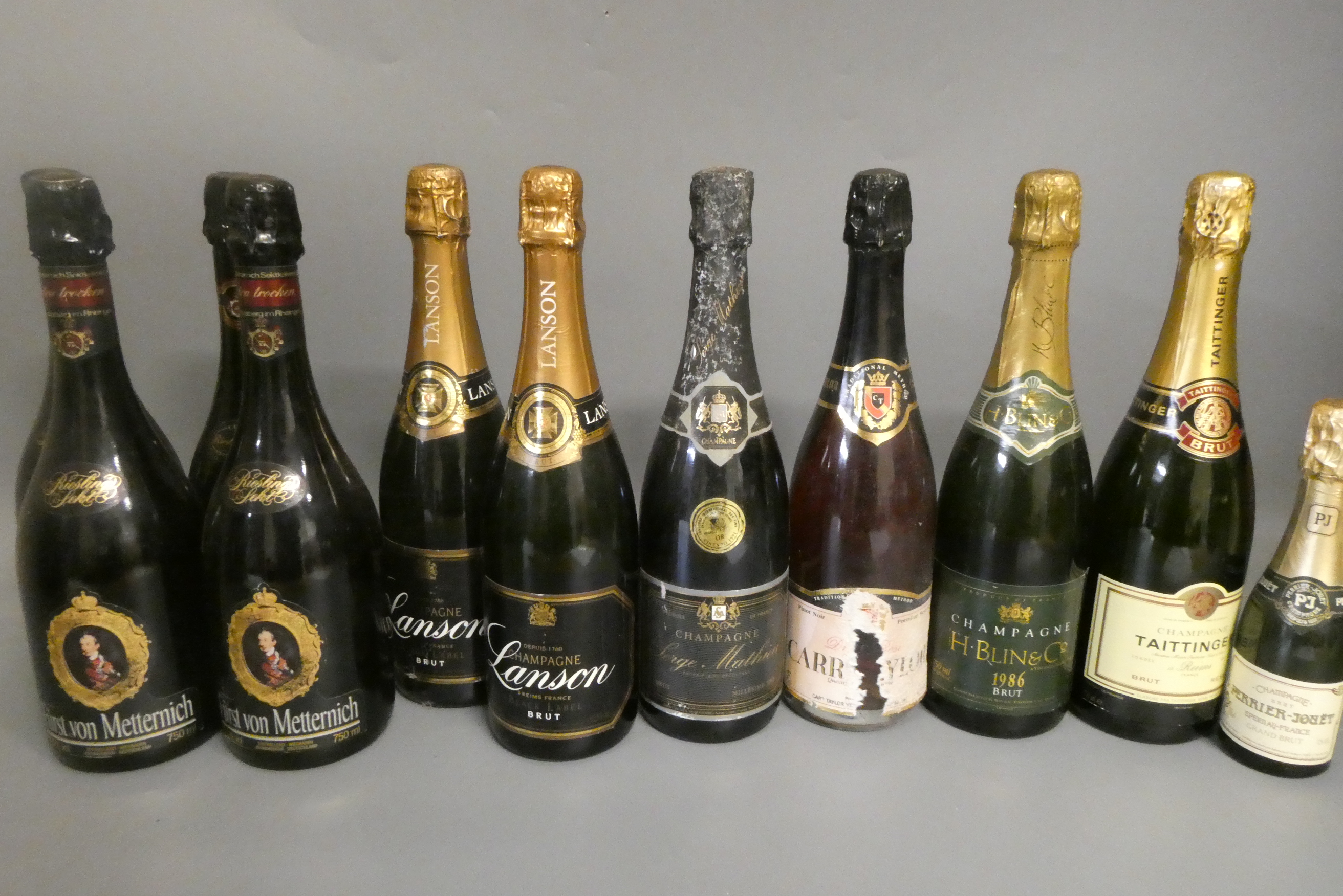 Ten full and one miniature bottles of mainly champagne Image