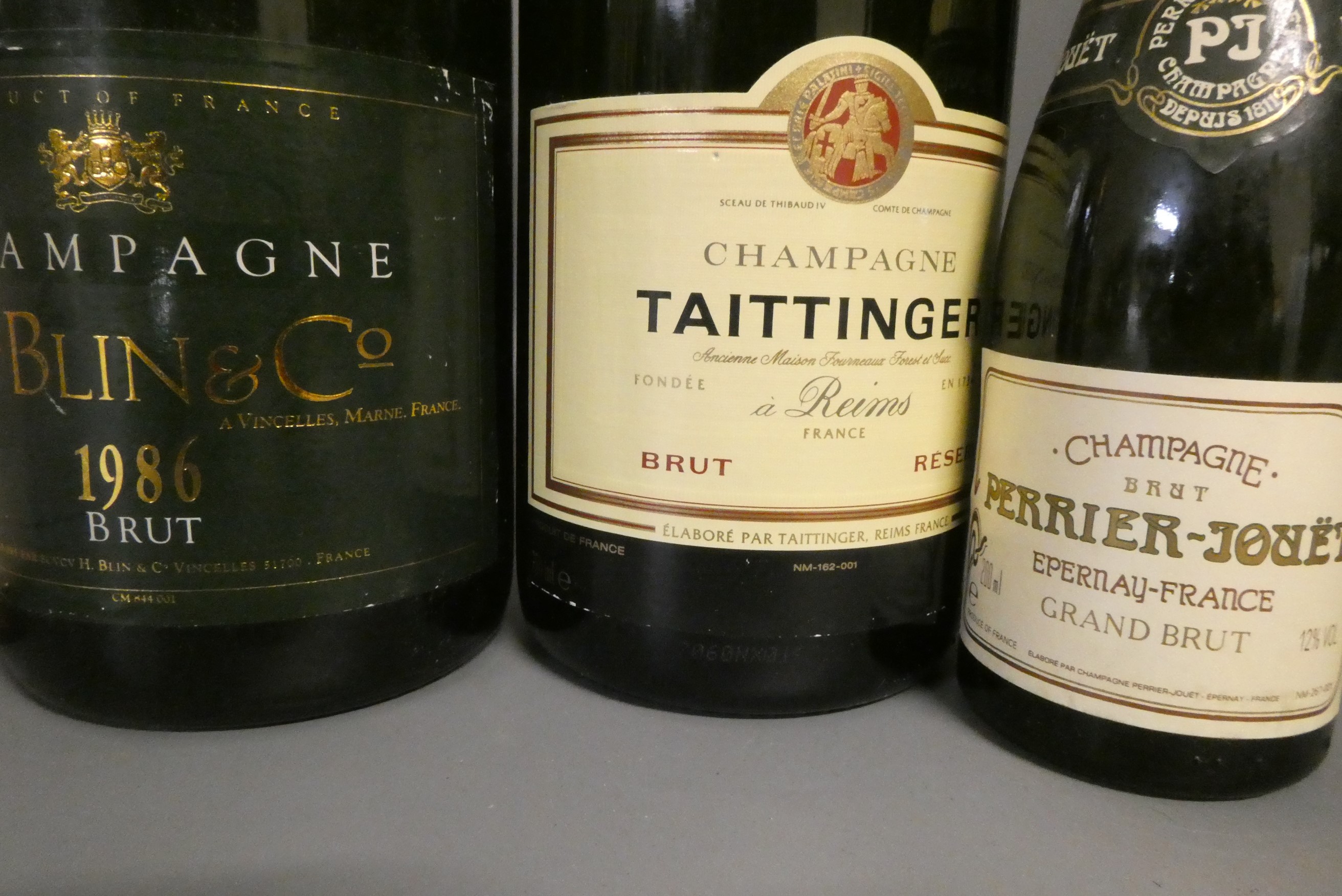 Ten full and one miniature bottles of mainly champagne Image