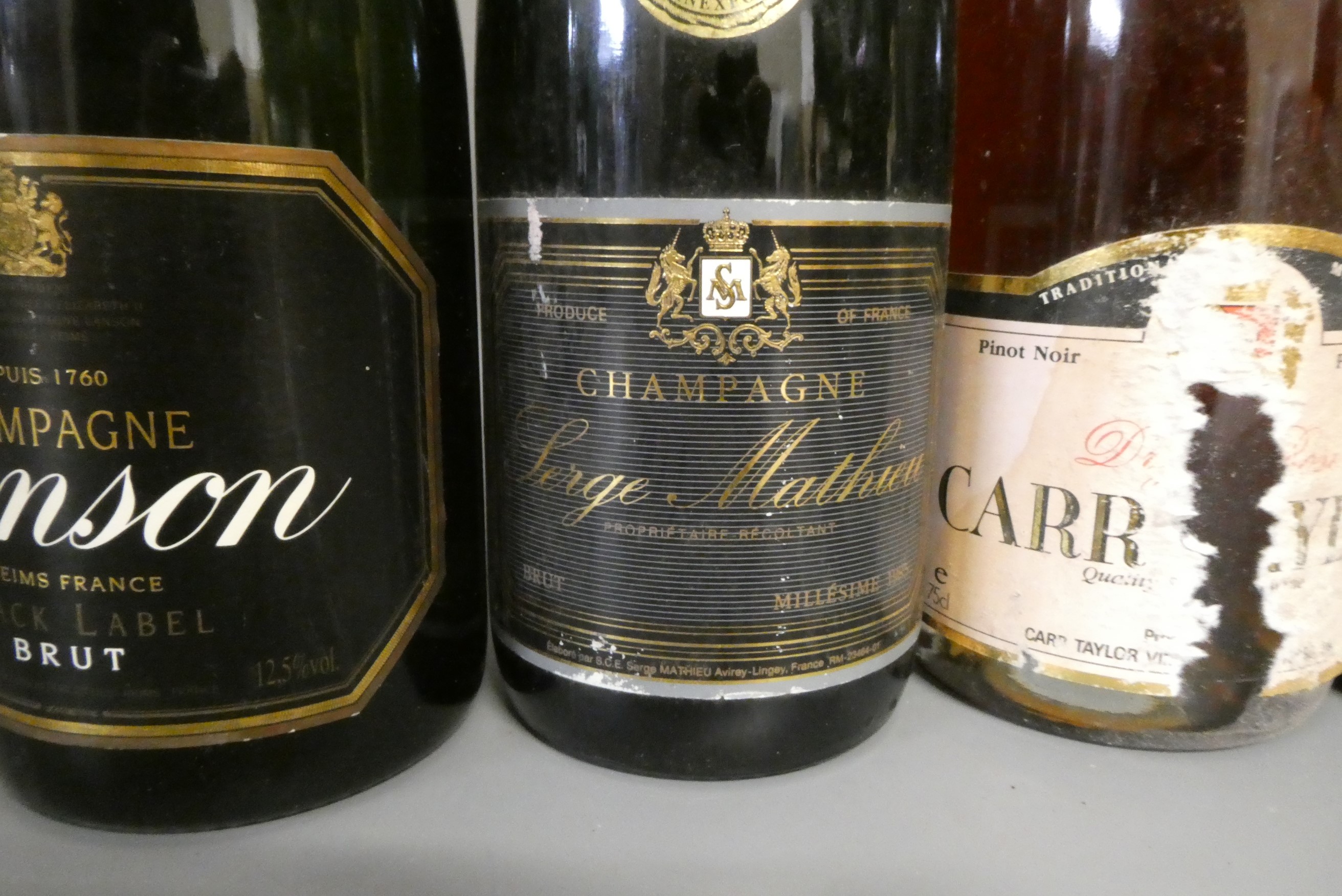 Ten full and one miniature bottles of mainly champagne Image