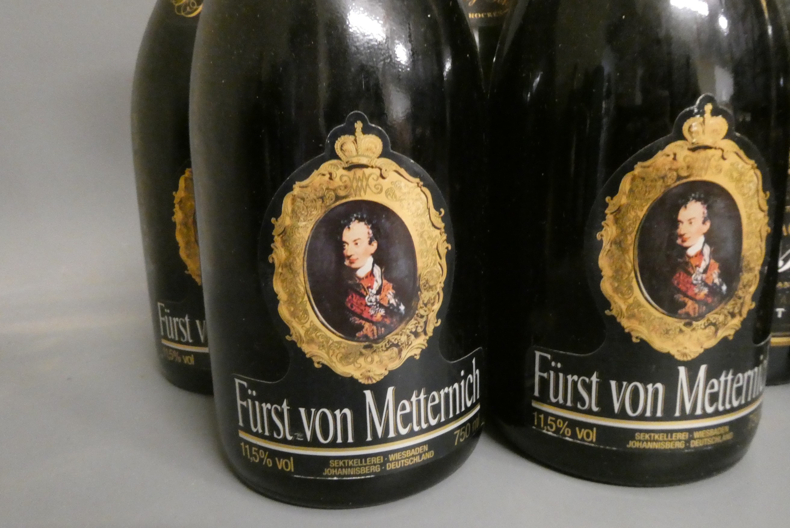 Ten full and one miniature bottles of mainly champagne Image