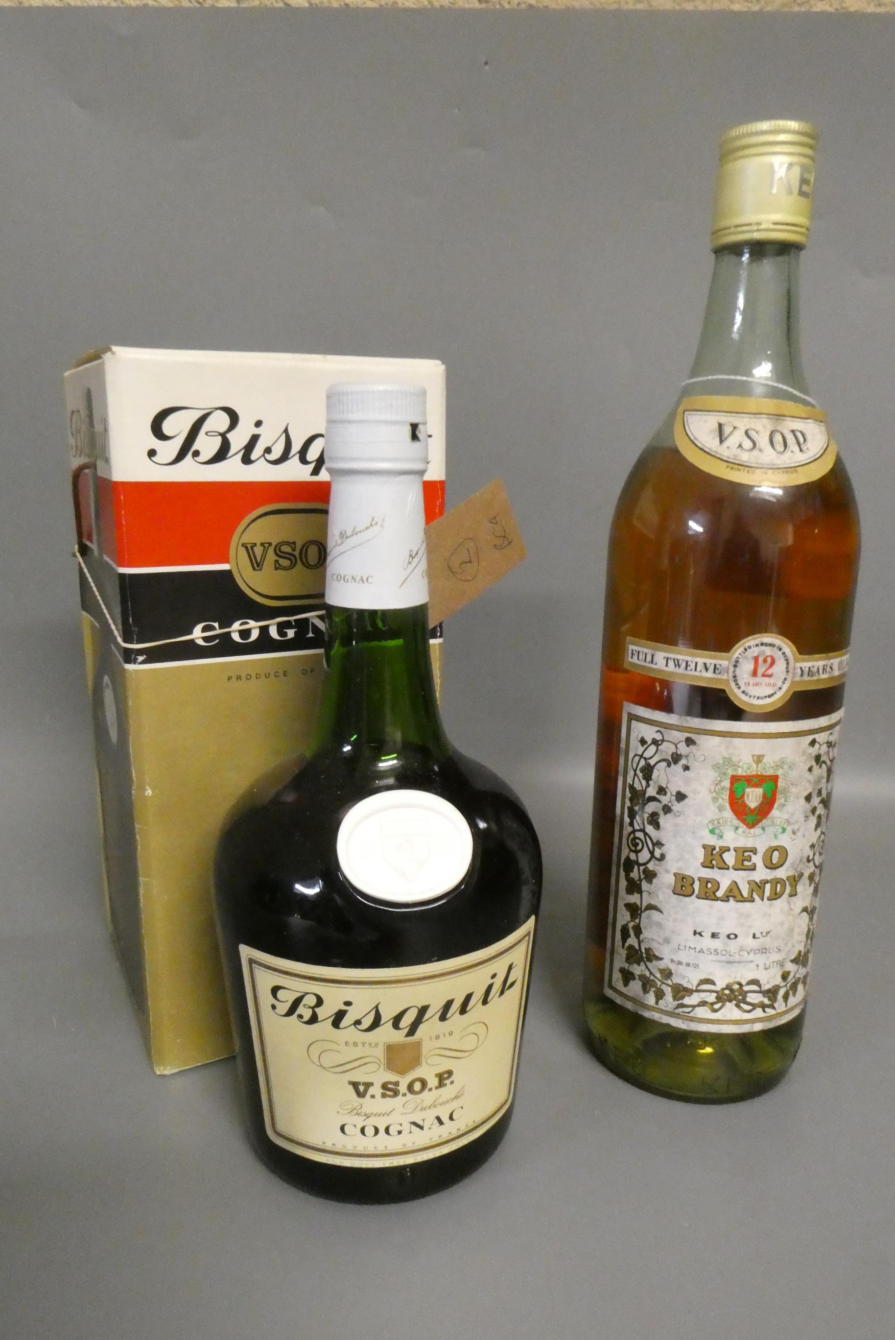 Two bottles of cognac and brandy, comprising a boxed bottle Bisquit VSOP cognac and a 1litre Keo Image