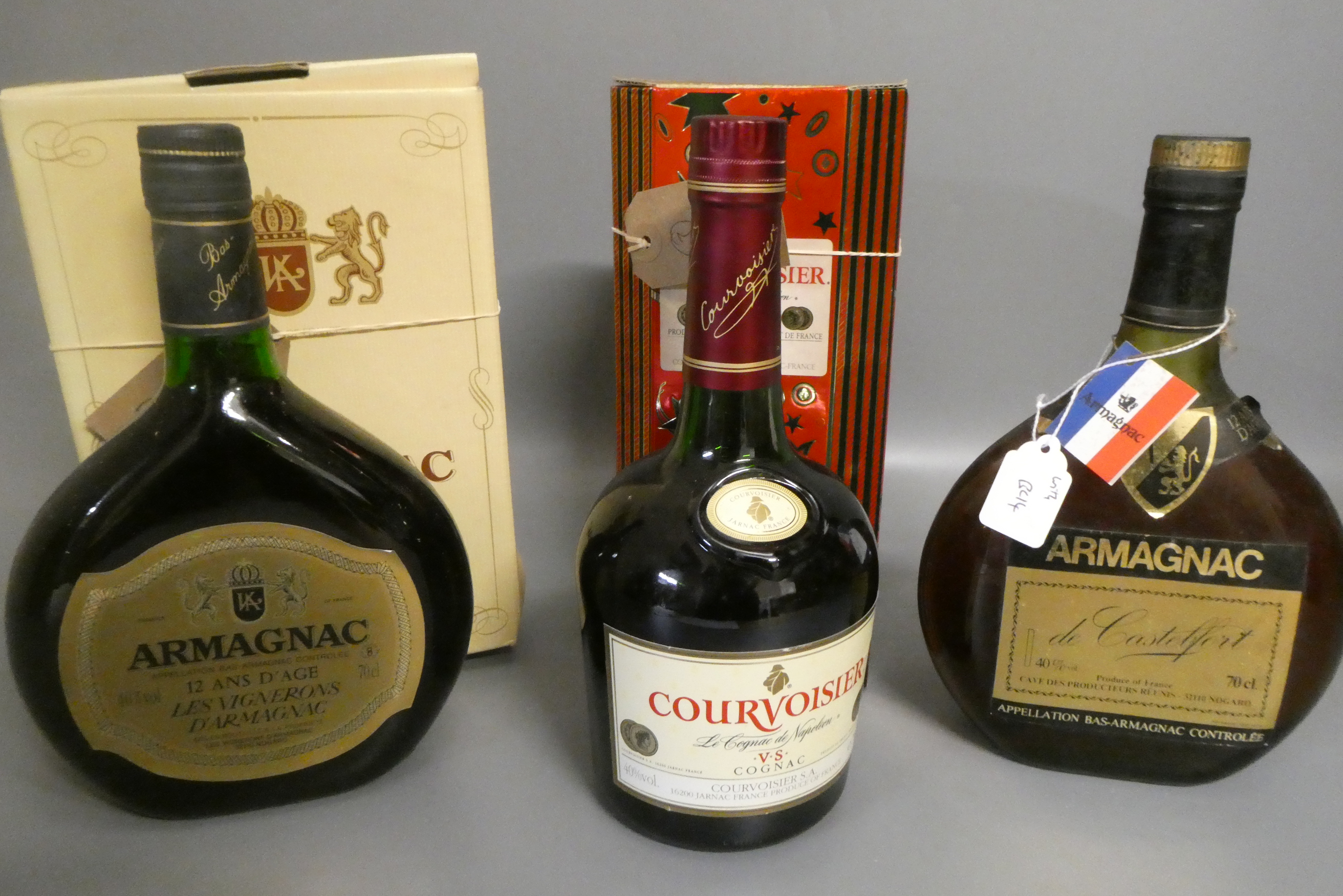 Three bottles of cognac & armagnac comprising a boxed Courvoisier VS cognac, a boxed 12yr old Image