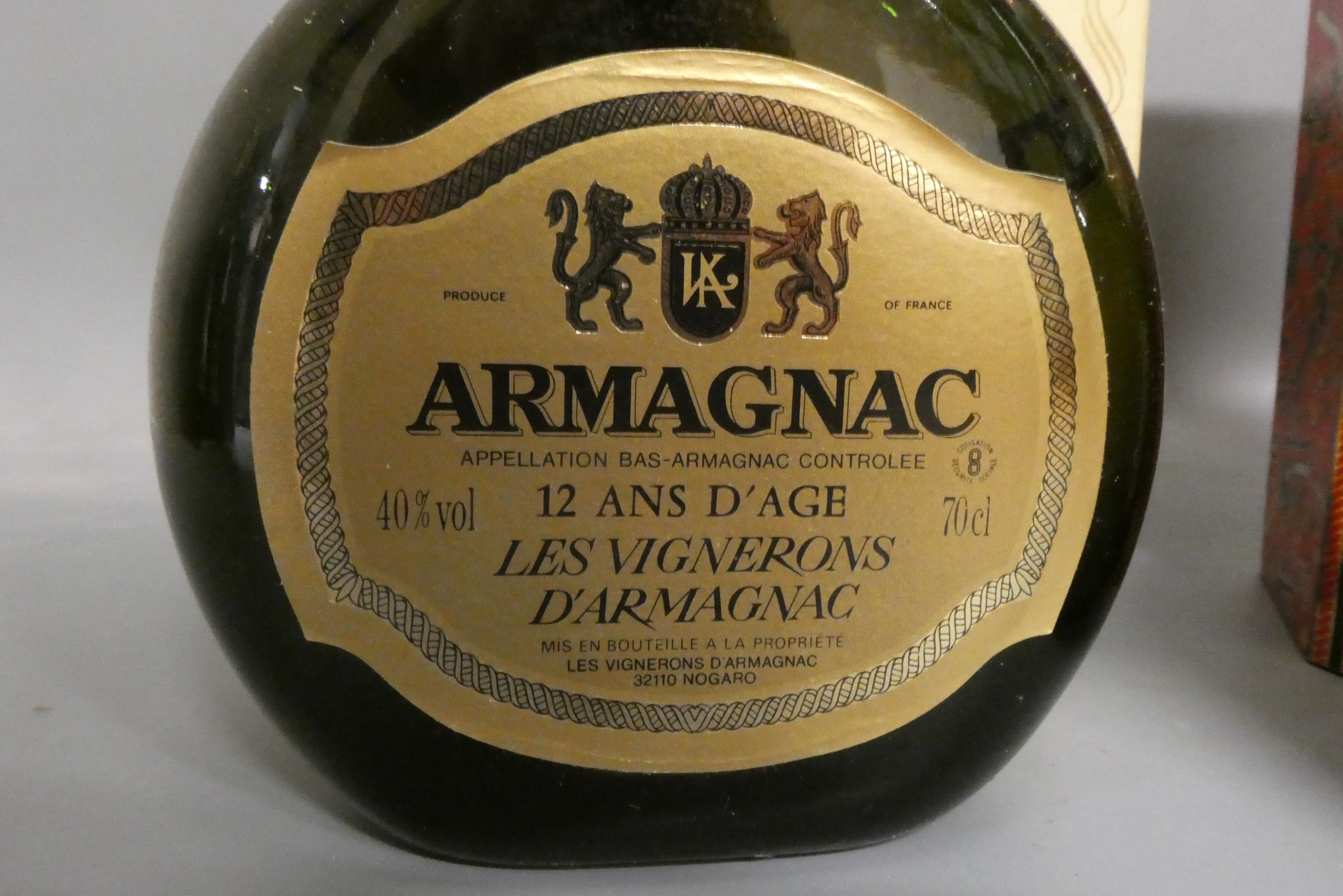 Three bottles of cognac & armagnac comprising a boxed Courvoisier VS cognac, a boxed 12yr old Image