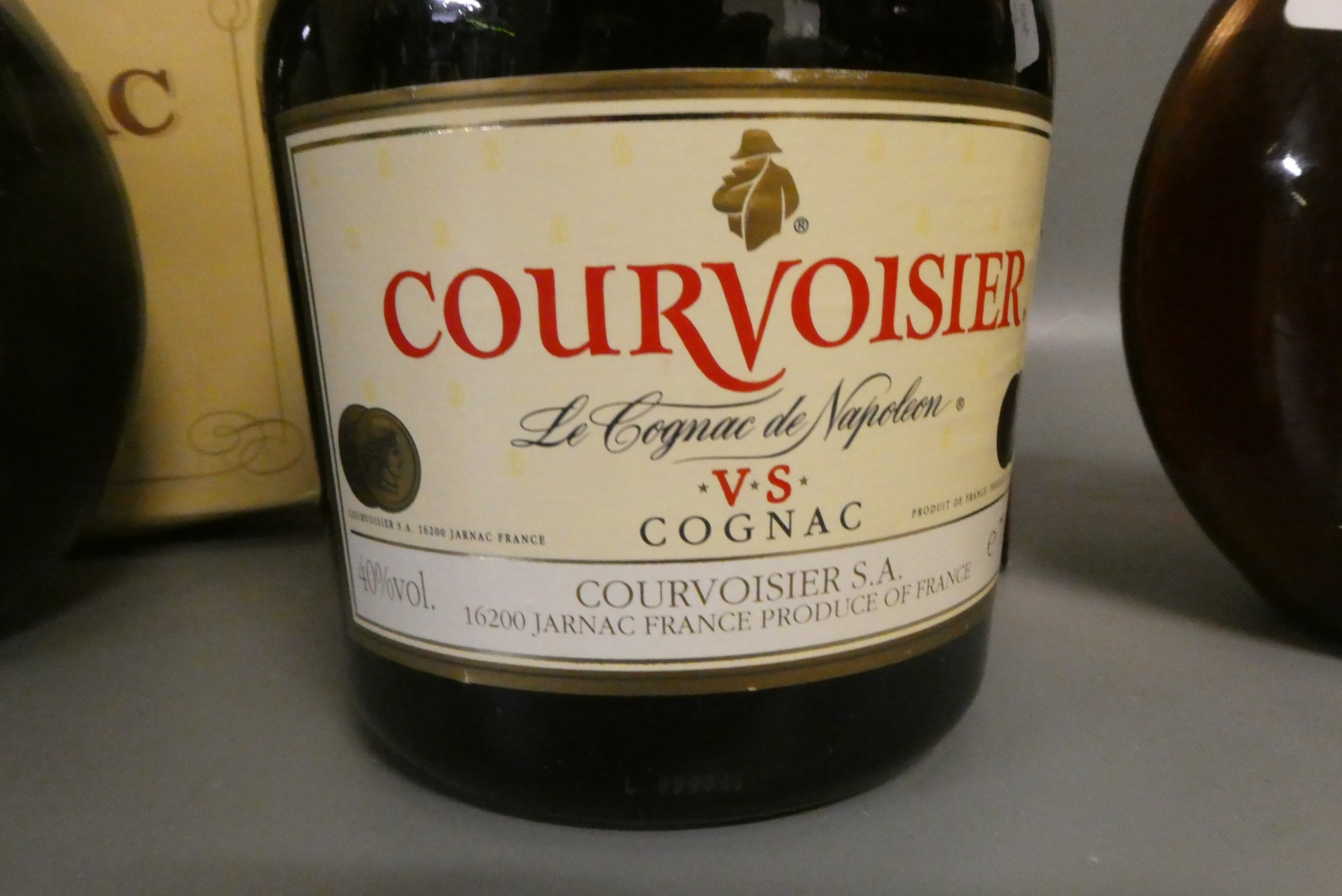 Three bottles of cognac & armagnac comprising a boxed Courvoisier VS cognac, a boxed 12yr old Image