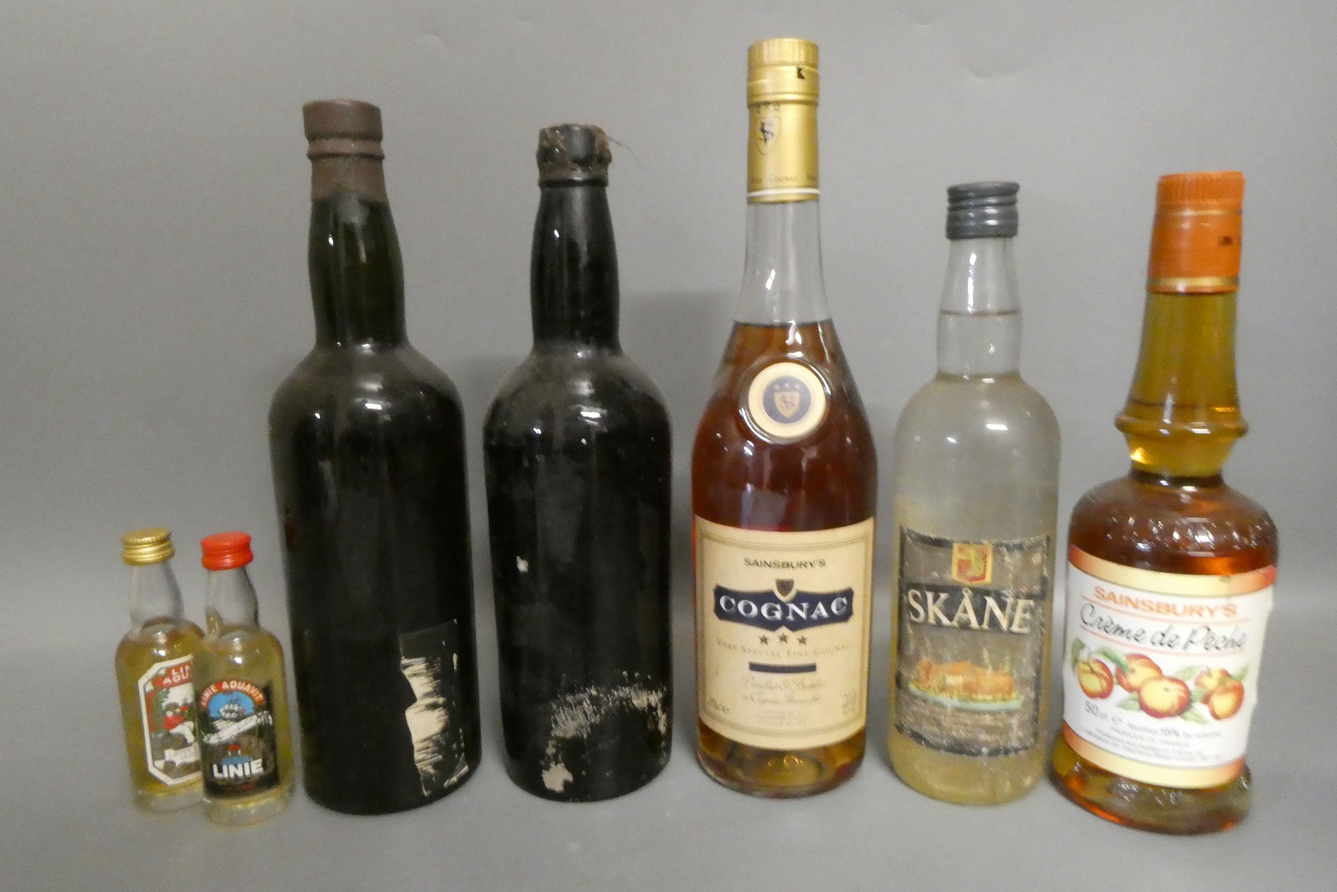 Five bottles and two miniatures of mixed port and liqueur Image