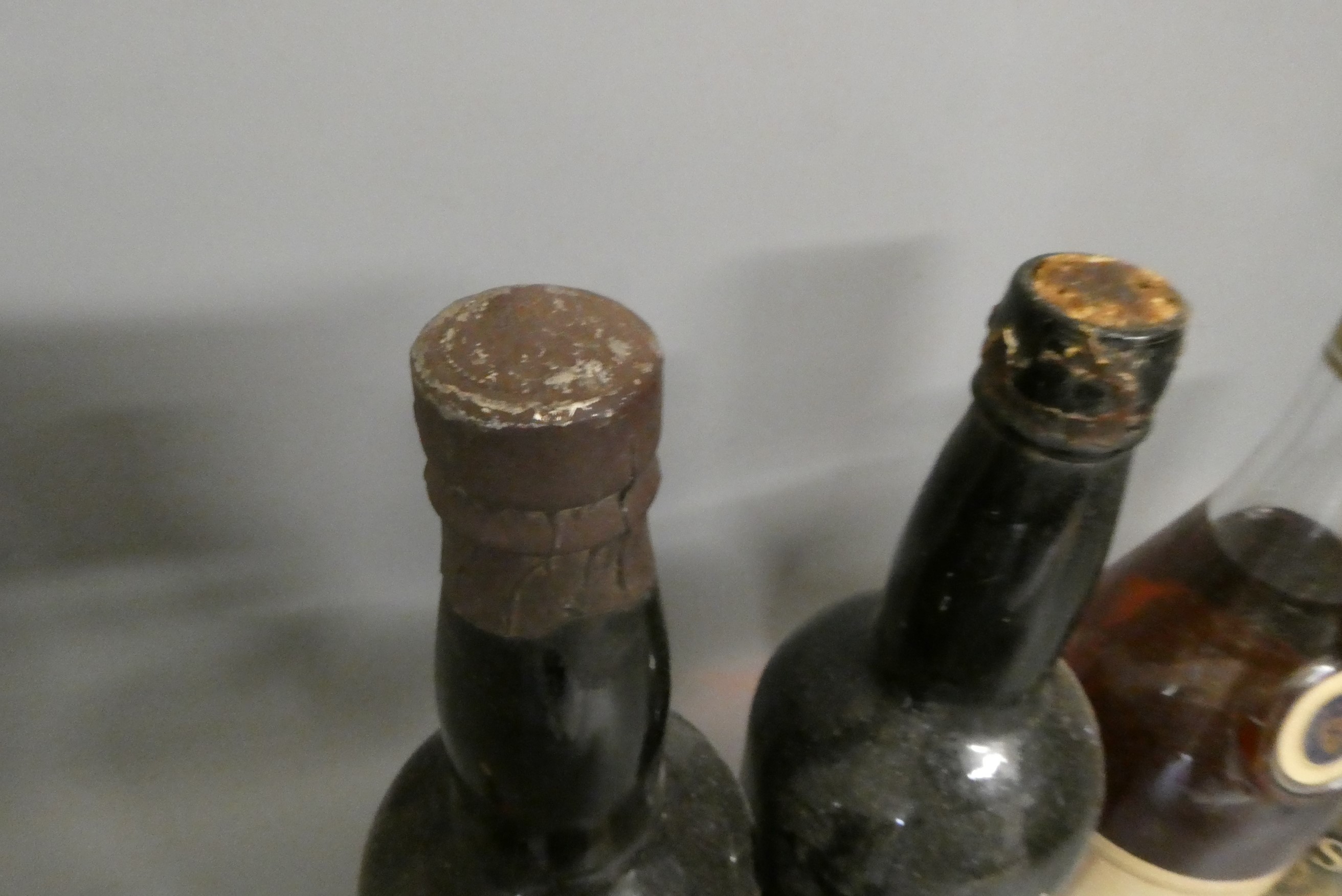 Five bottles and two miniatures of mixed port and liqueur Image