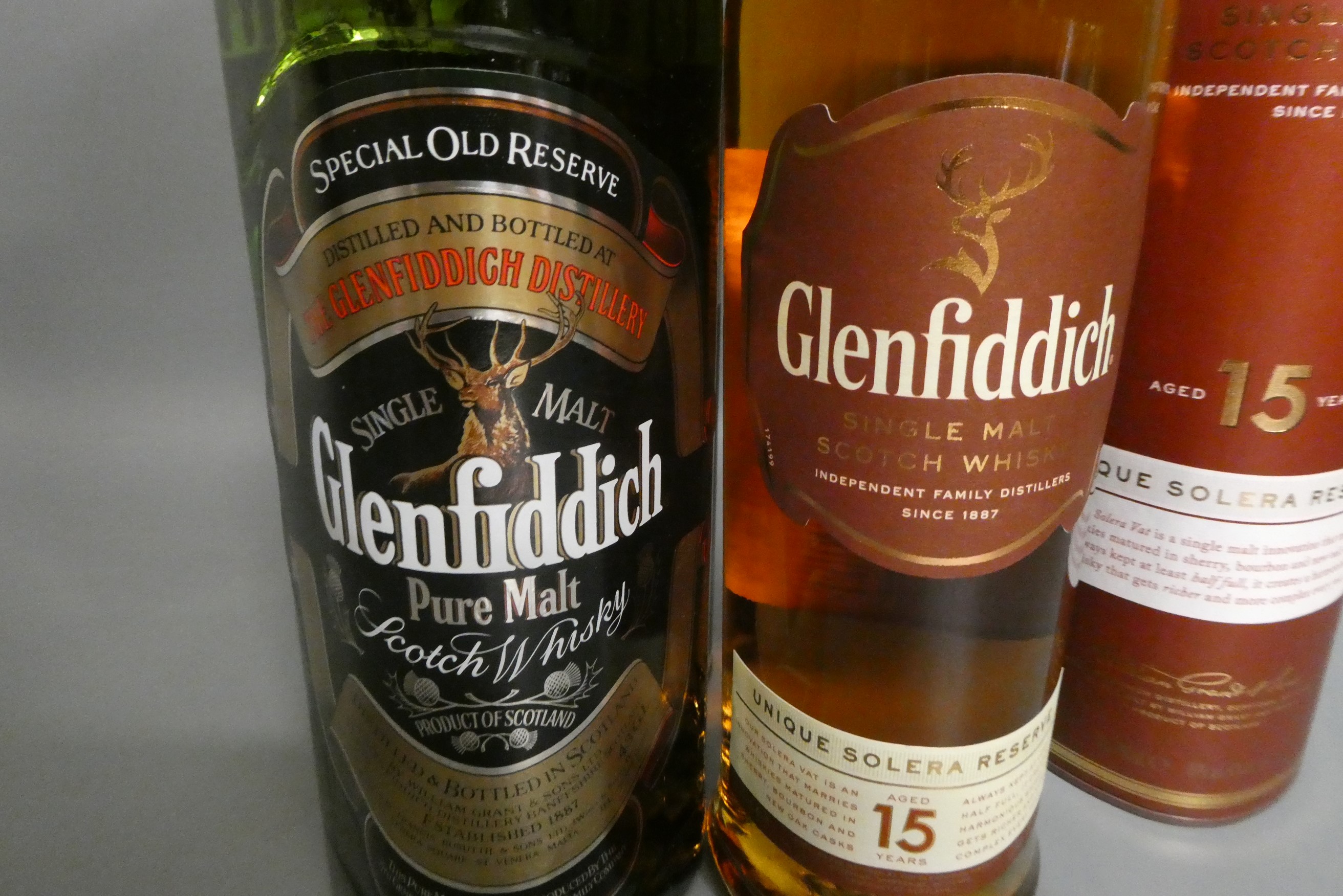 Two bottles of Glenfiddich malt scotch whisky, comprising 1litre pure malt and 70cl 15yr old Unique Image