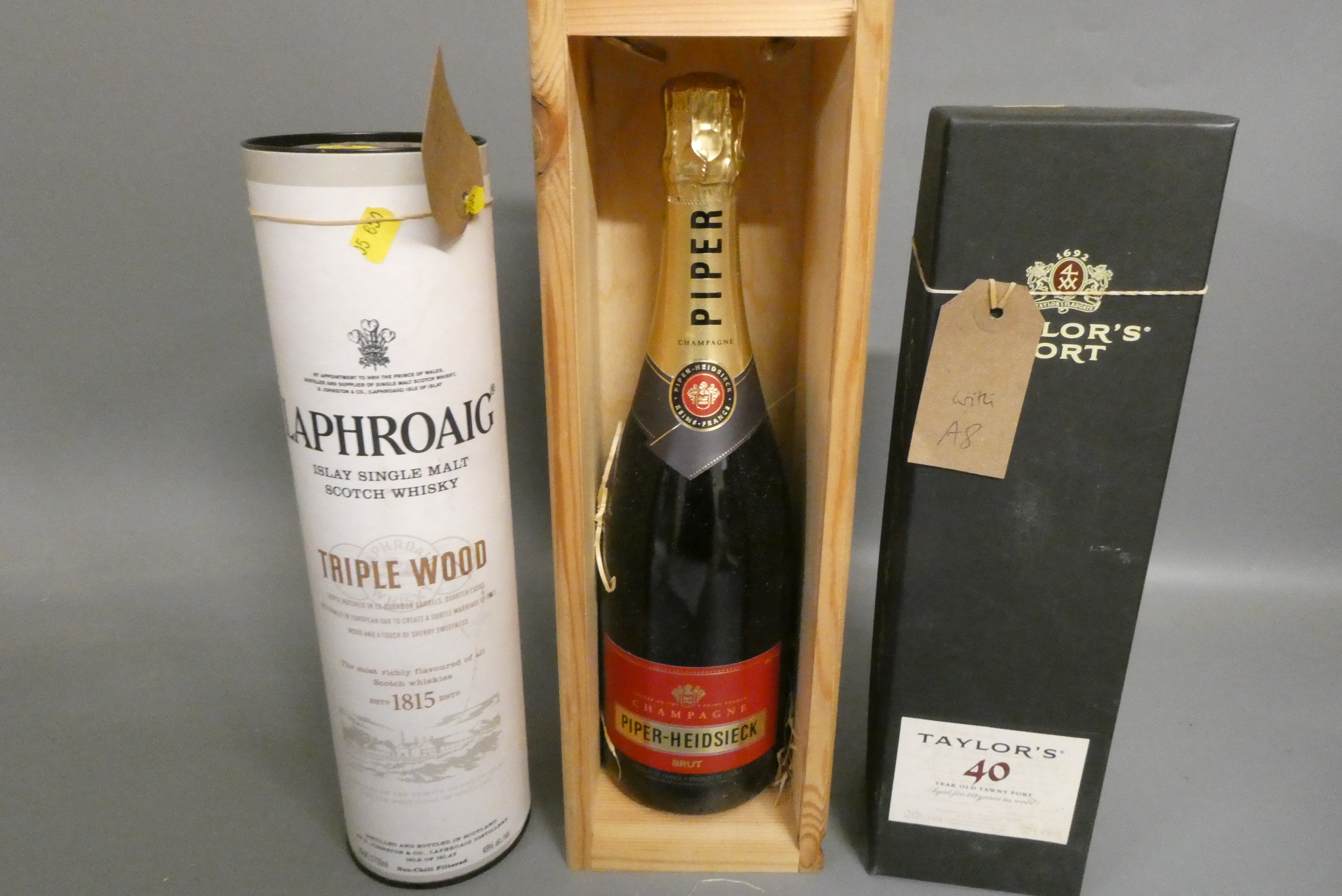 Three boxed bottles comprising a Laphroaig triple wood single malt whisky, a Taylor's 40yr old tawny Image