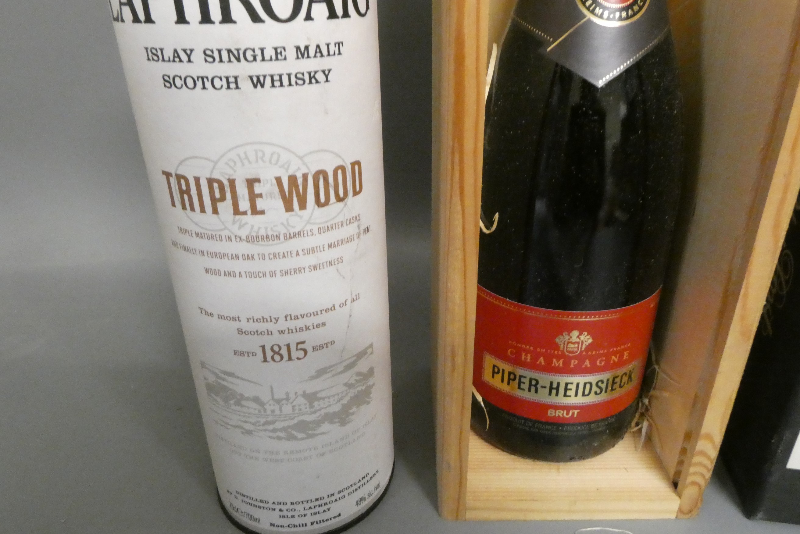 Three boxed bottles comprising a Laphroaig triple wood single malt whisky, a Taylor's 40yr old tawny Image