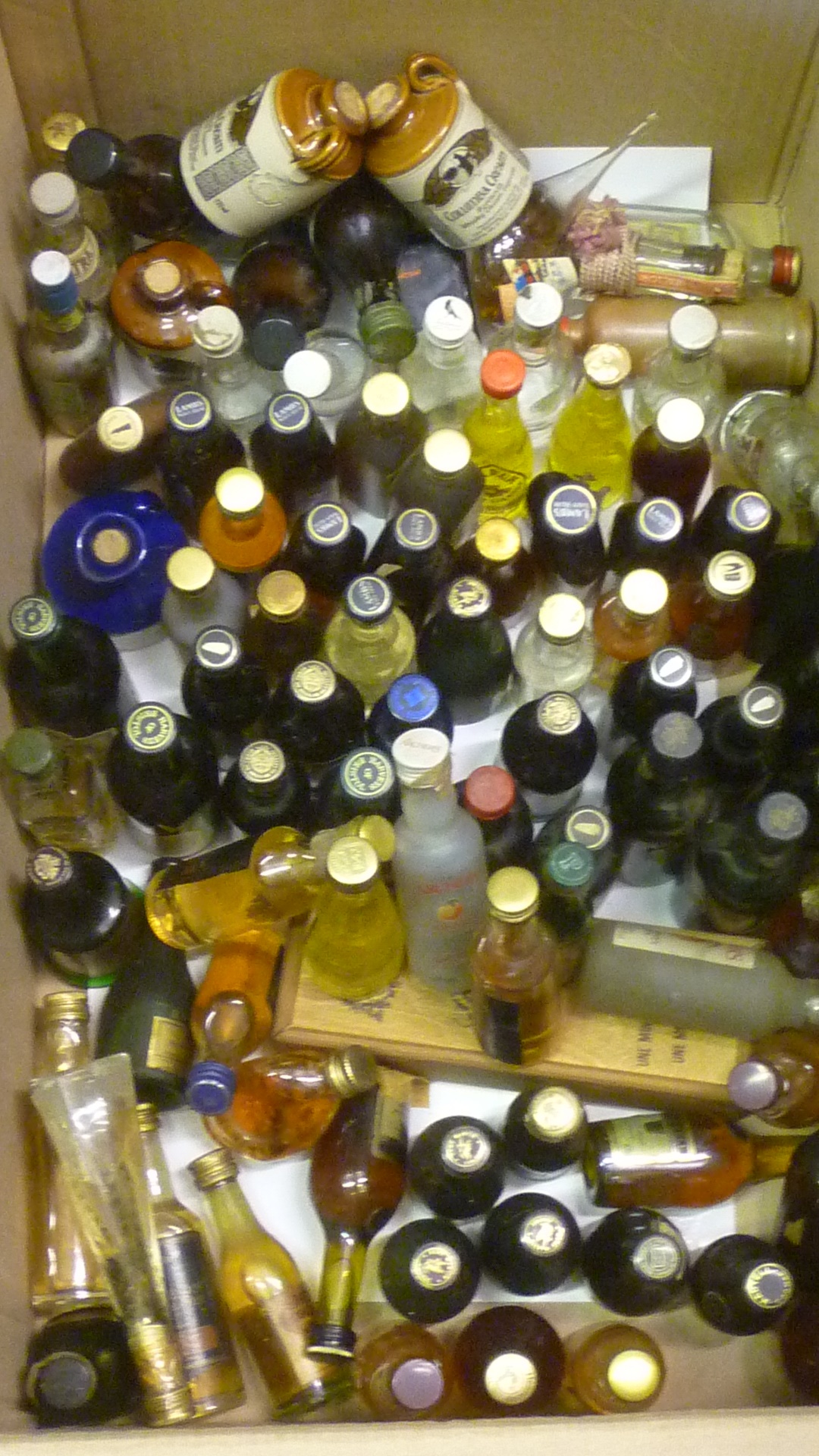 Approximately one hundred miniatures of liqueurs Image