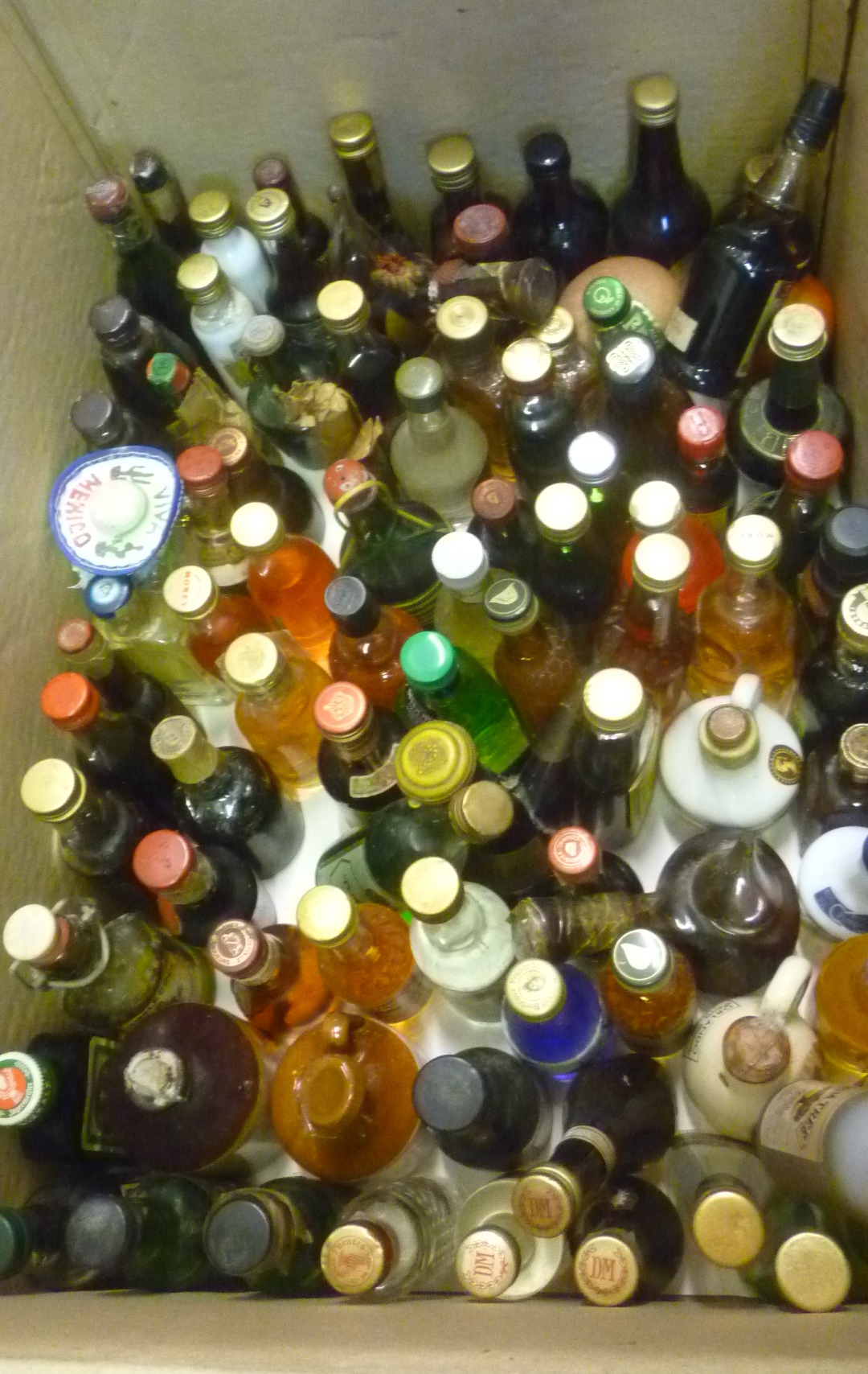 Approximately one hundred miniatures of liqueurs Image