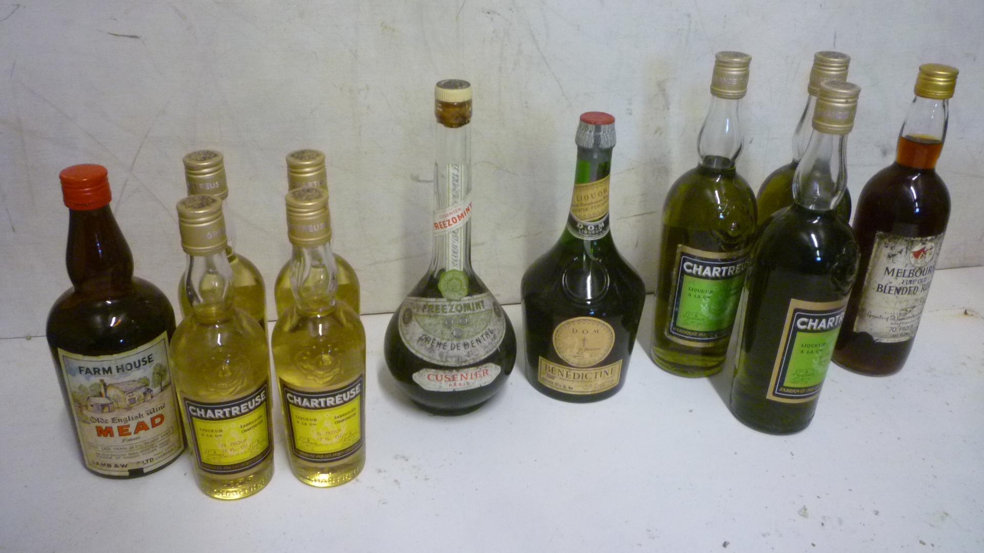 Three bottles and four half bottles Chartreuse Image