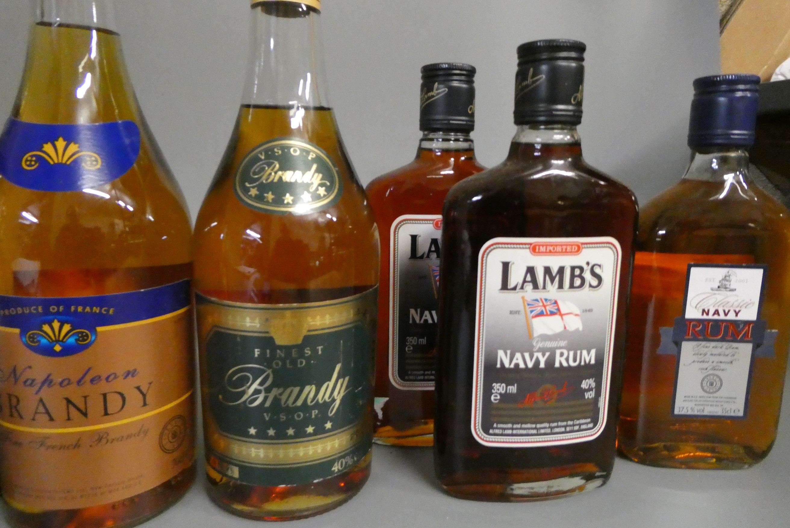 A collection of mixed spirits and liqueur, including Lambs navy rum, Classic navy rum, Napoleon Image