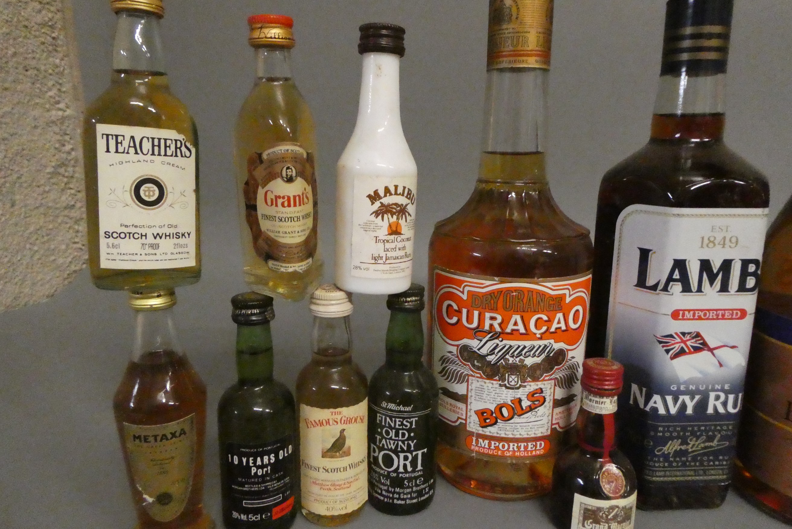A collection of mixed spirits and liqueur, including Lambs navy rum, Classic navy rum, Napoleon Image