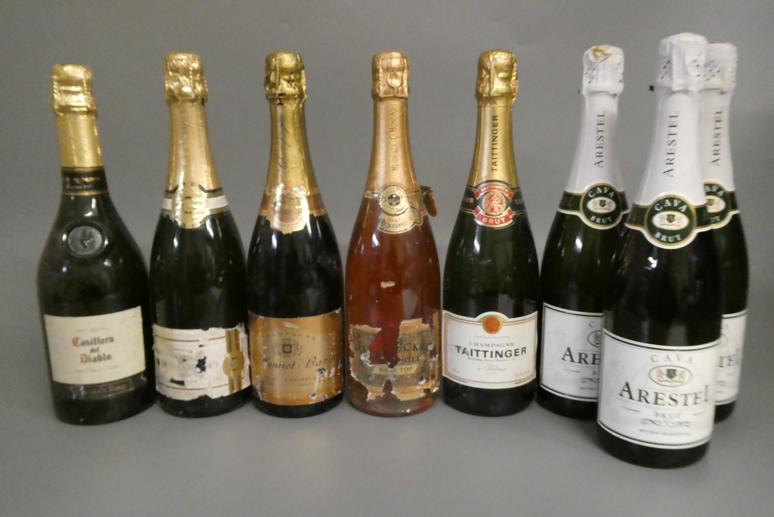8 bottles of sparkling wine Image