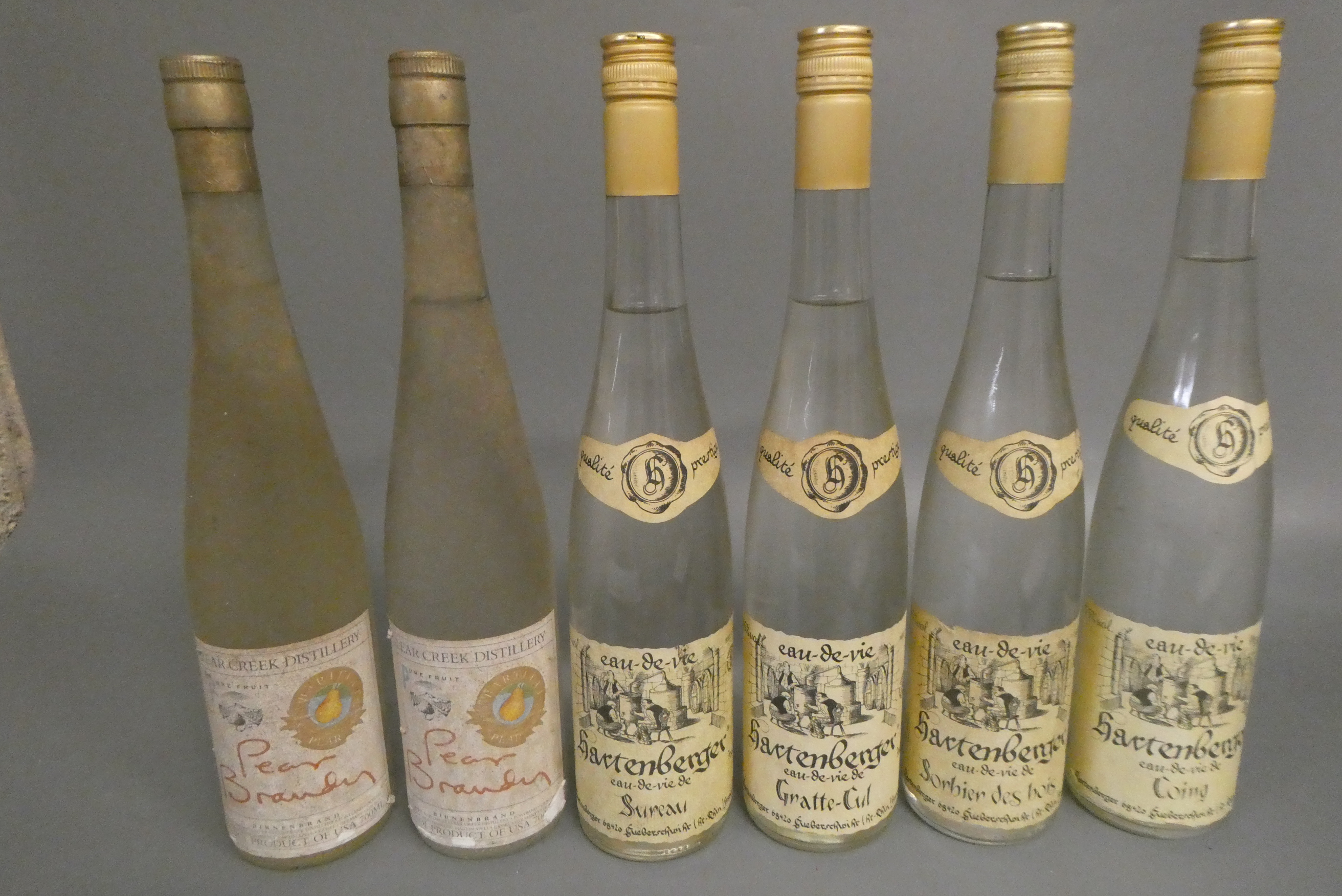 4 bottles Hartenberger Eau-de-Vie de Coing, 40%, together with 2 Clear Creek Distillery Pear Brandy Image