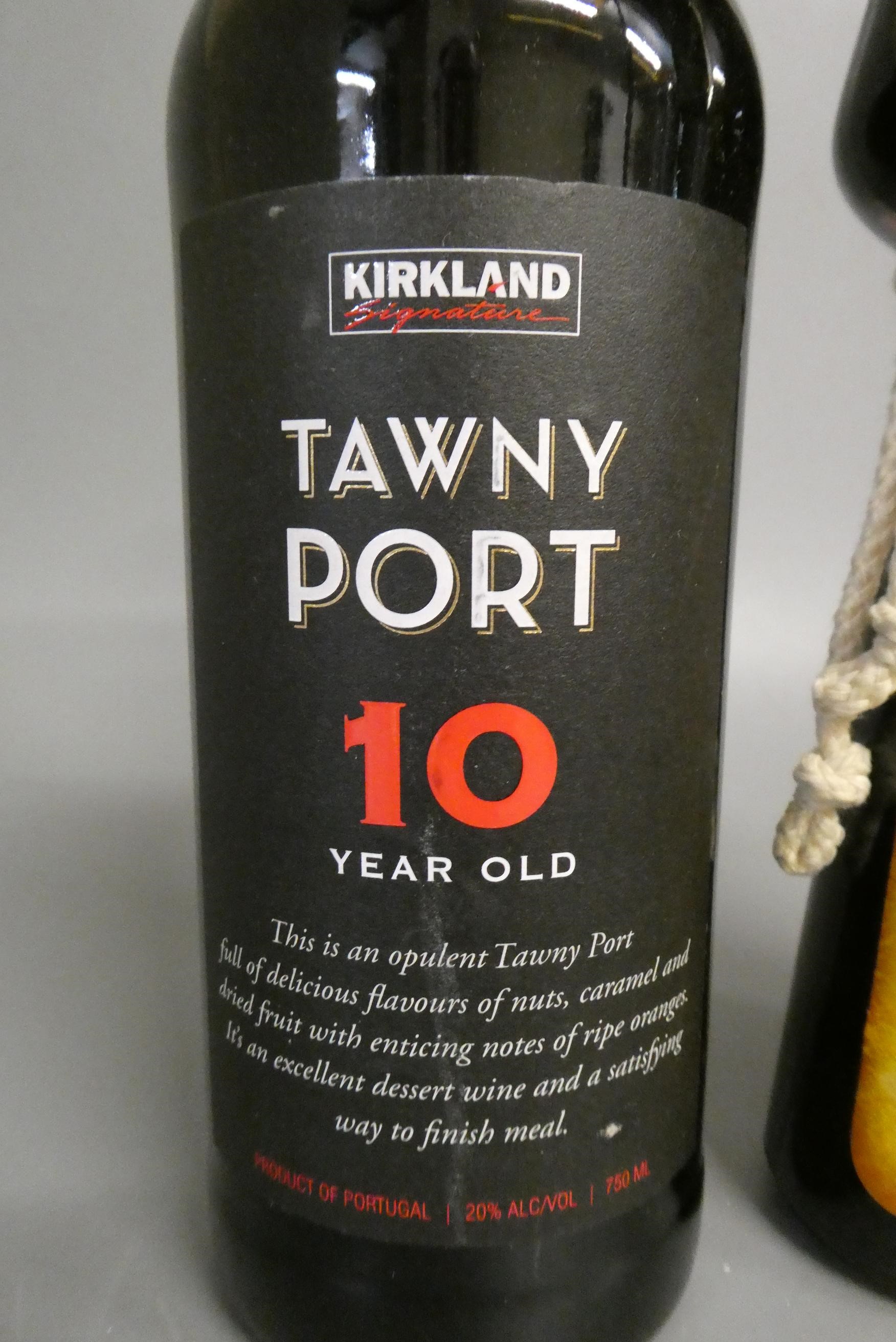 2 bottles comprising a 10 year old Tawny Port, Kirkland signature, and a Frangelico liqueur (Est. Image