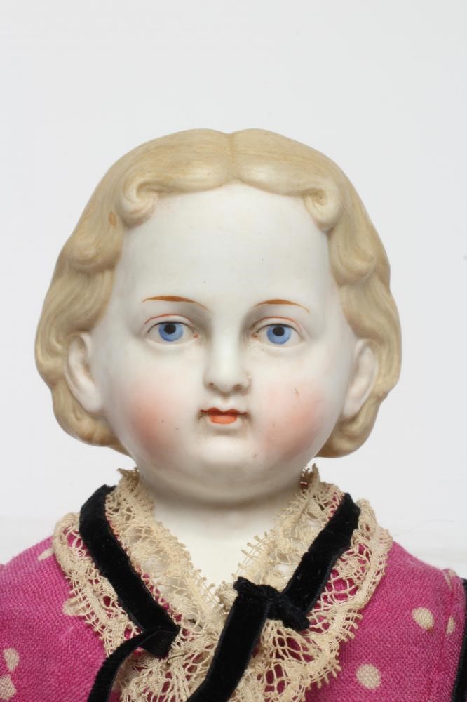 An early ABG bisque shoulder head doll, c. 1890, with moulded hair, painted features, fabric body, Image