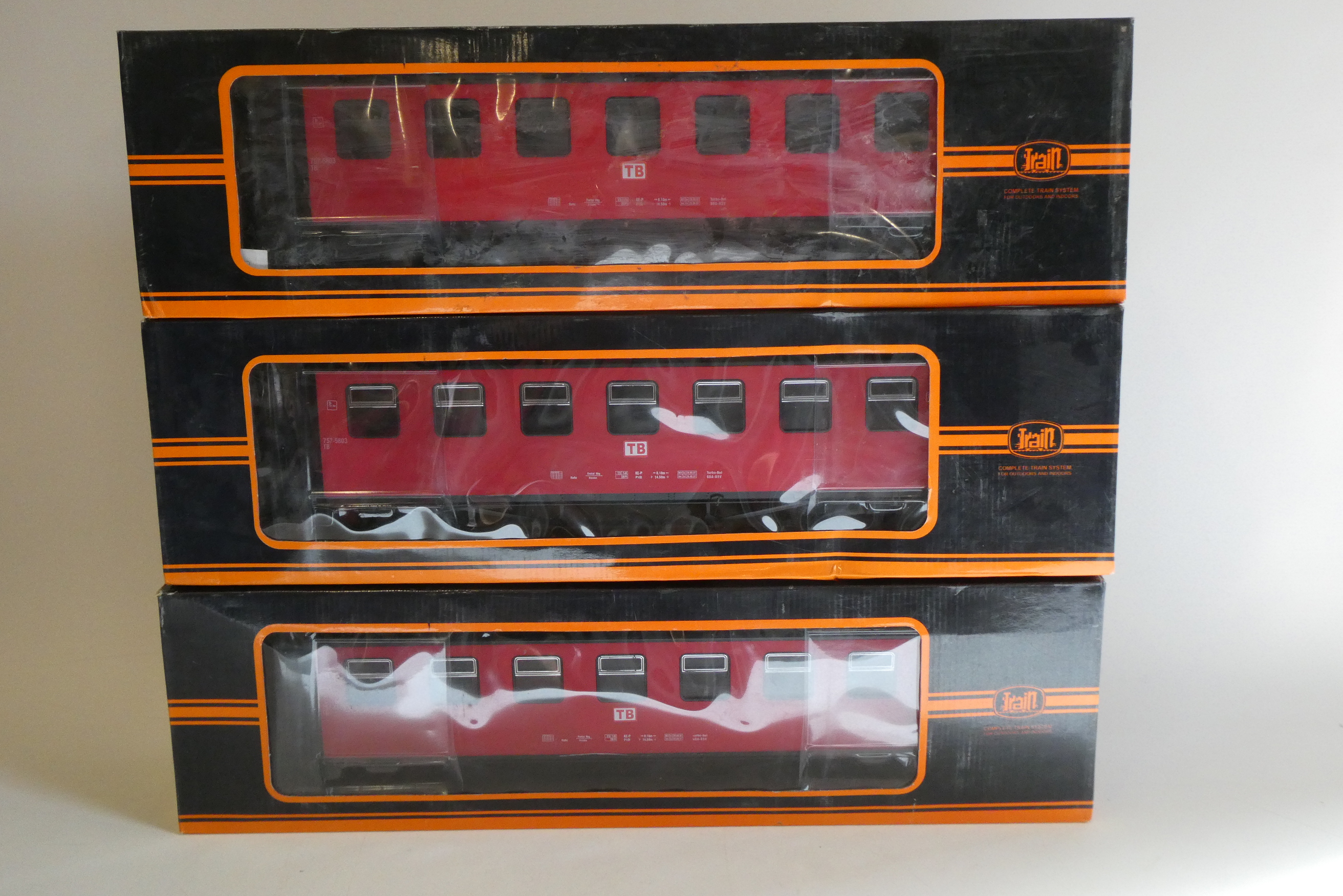 Three bogie coaches of German railway type finished in red, boxed, good to excellent Image