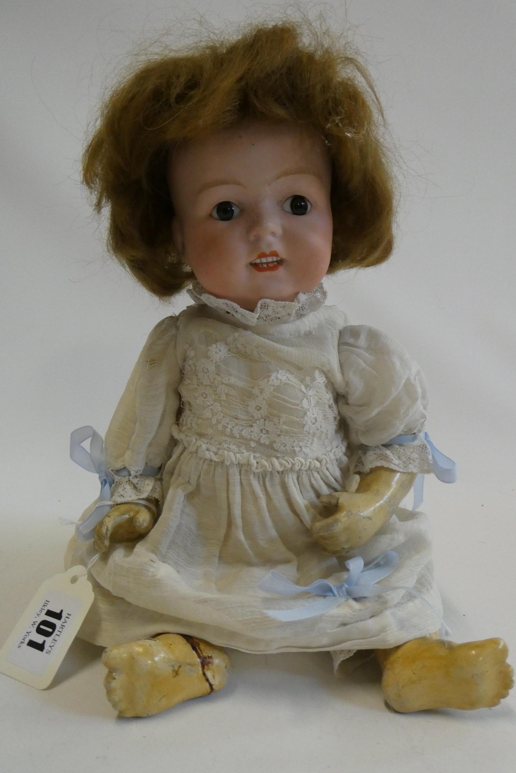 A German bisque socket head character doll, with brown glass fixed eyes, moulded grinning teeth, Image