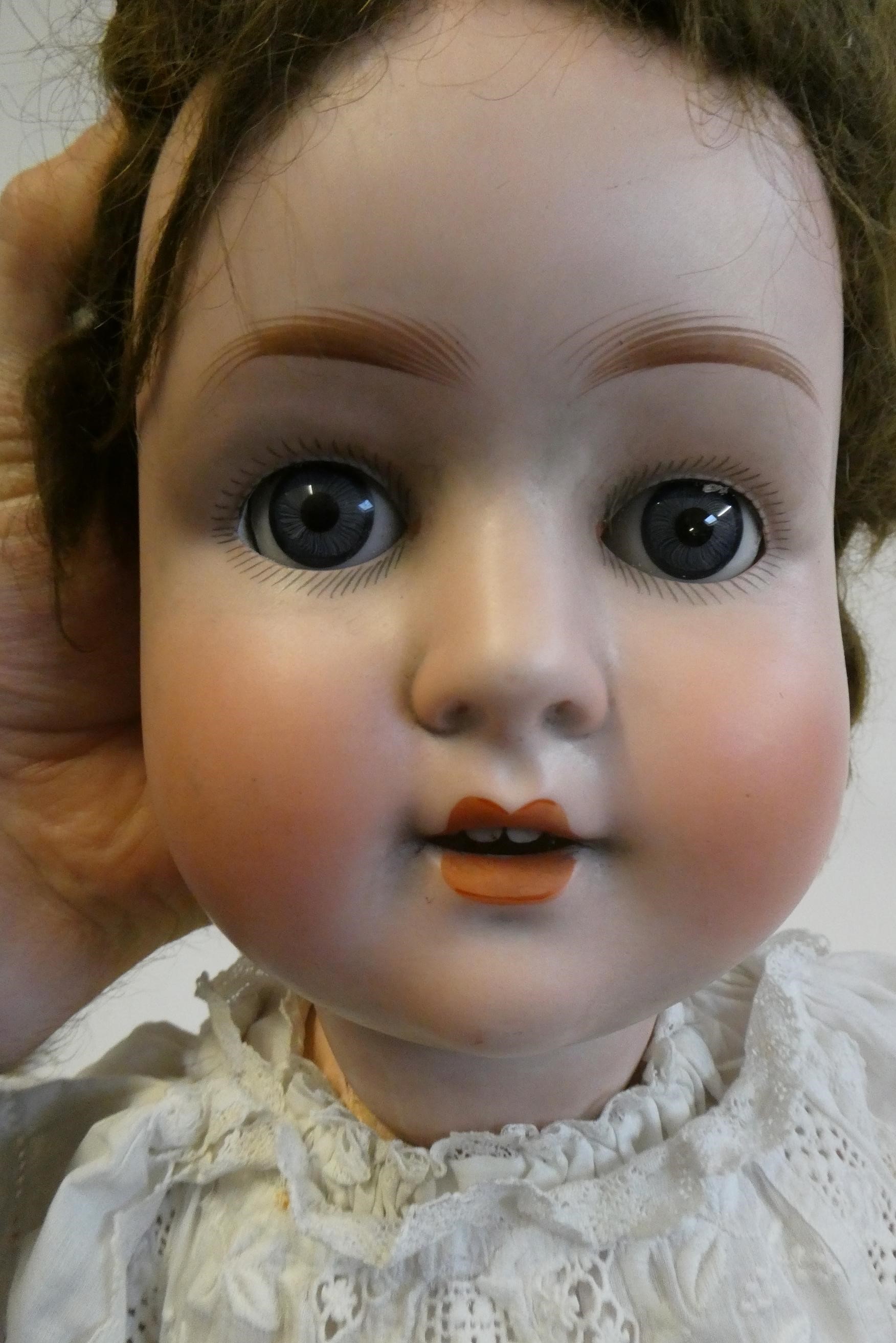 A Schoenau & Hoffmeister bisque socket head doll, with blue glass sleeping eyes, open mouth, teeth, Image