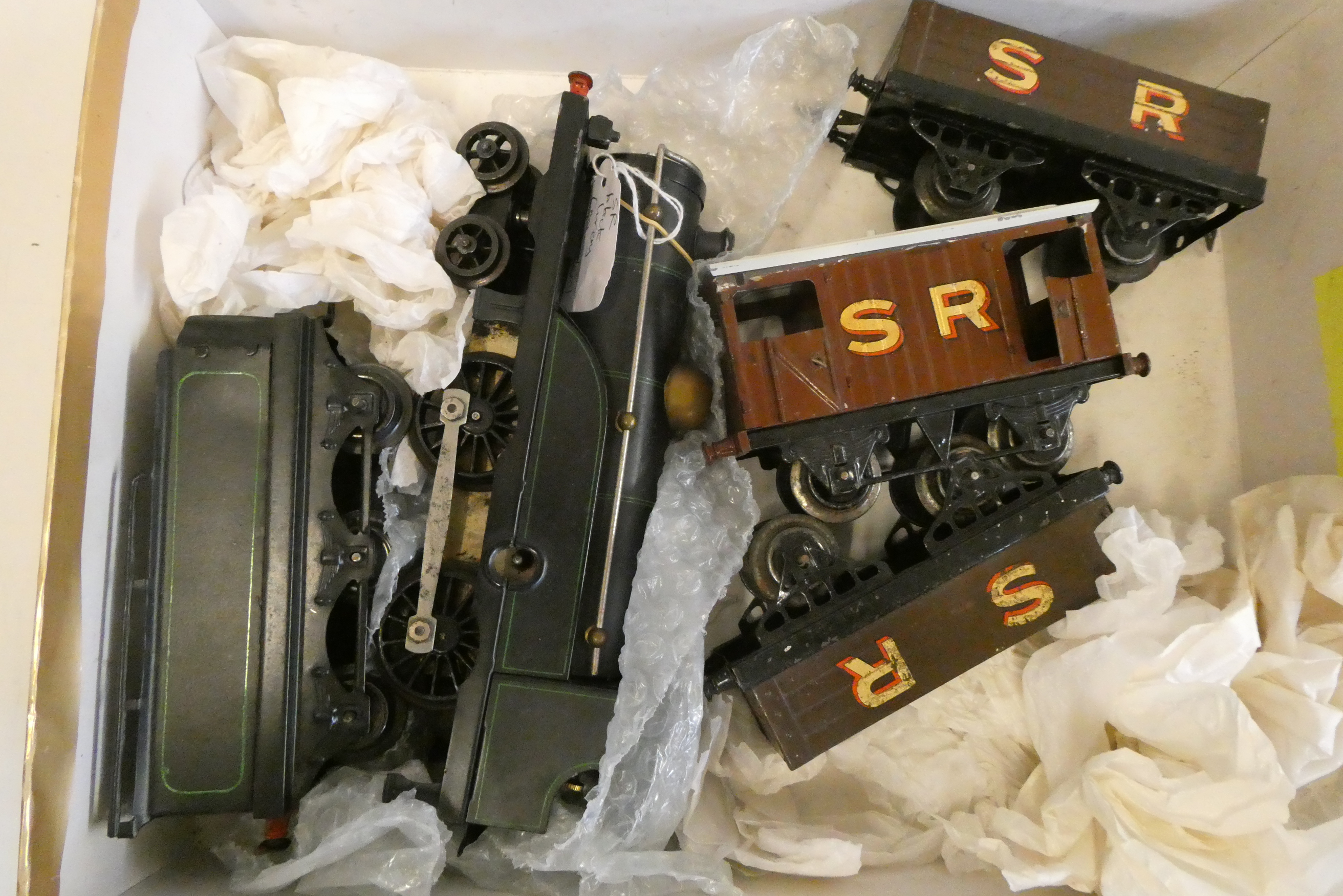 Repainted Hornby clockwork located in black with green lining and three Southern Railway goods Image