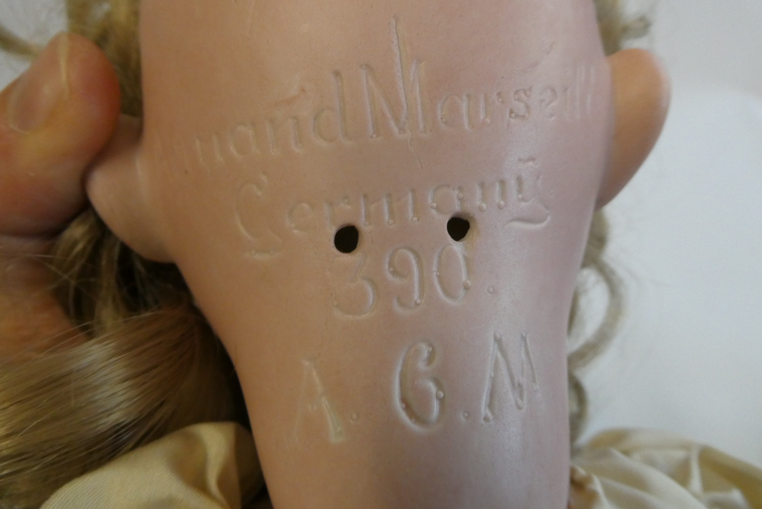 An Armand Marseille bisque socket head doll, with blue glass sleeping eyes, open mouth, teeth, blond Image