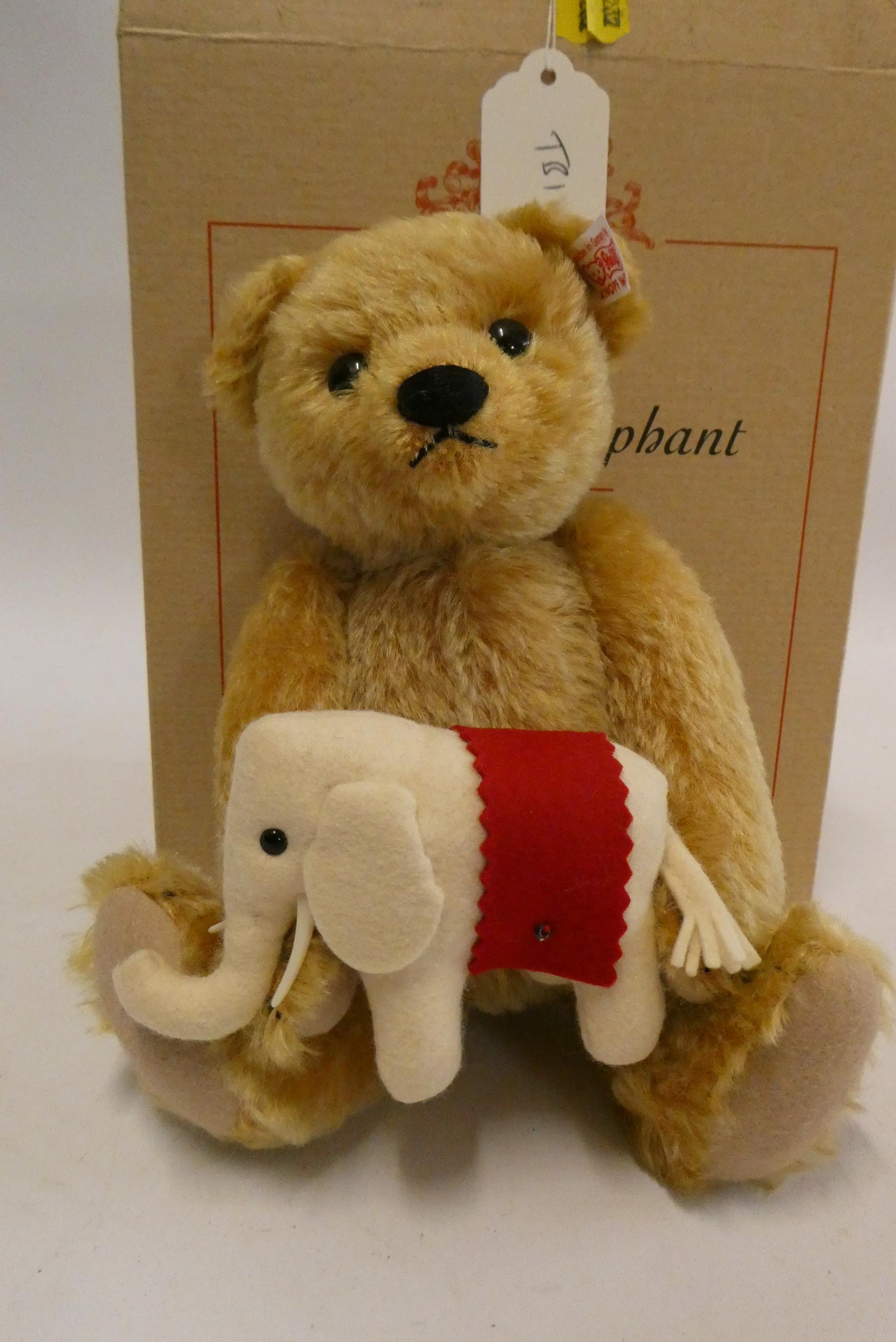 Steiff "Teddy's Elephant" bear, a 24cm bear holding a felt elephant, with ear button, label and Image