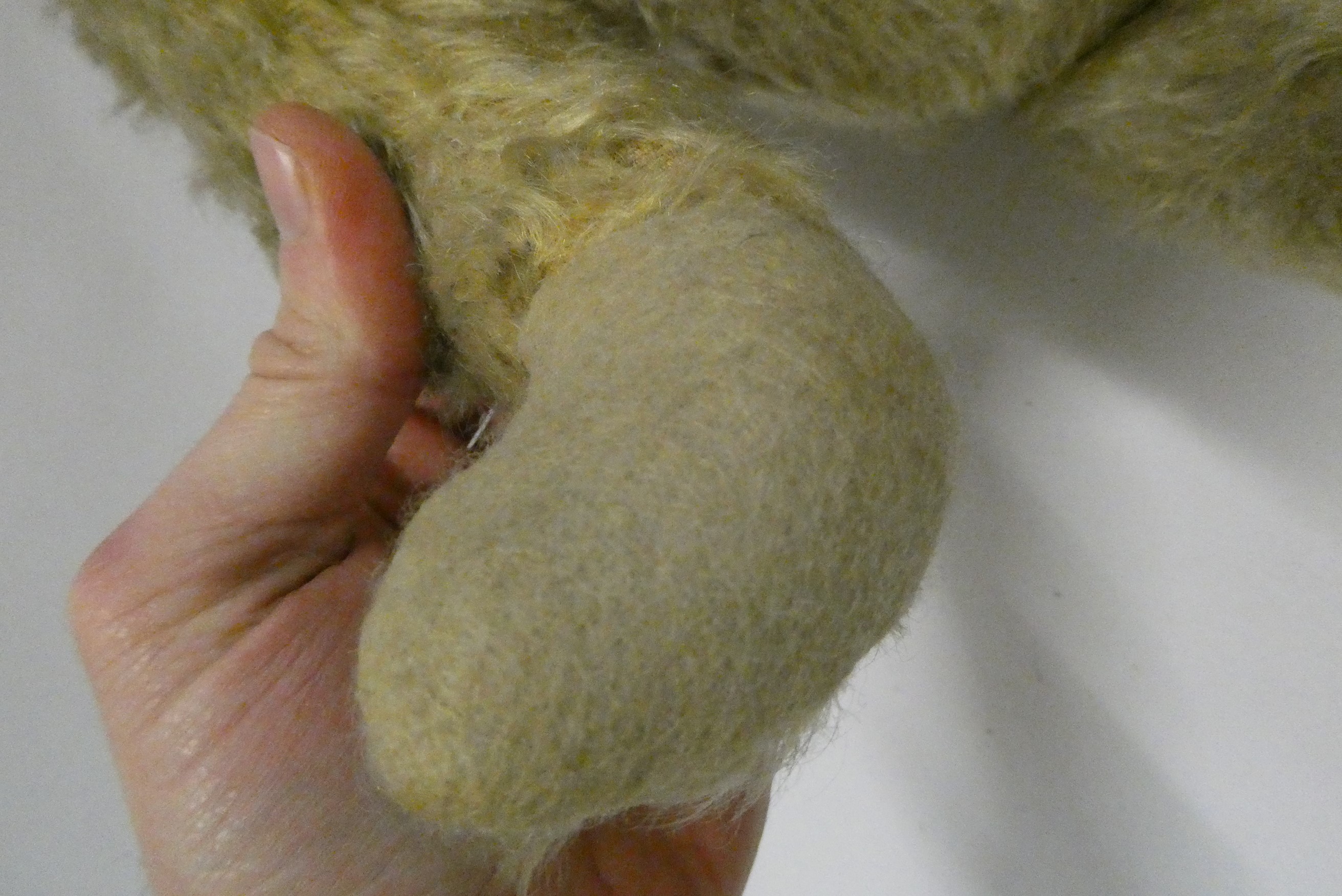 Two old straw filled teddies, comprising a 20" vintage English bear with shaven muzzle, amber eyes Image