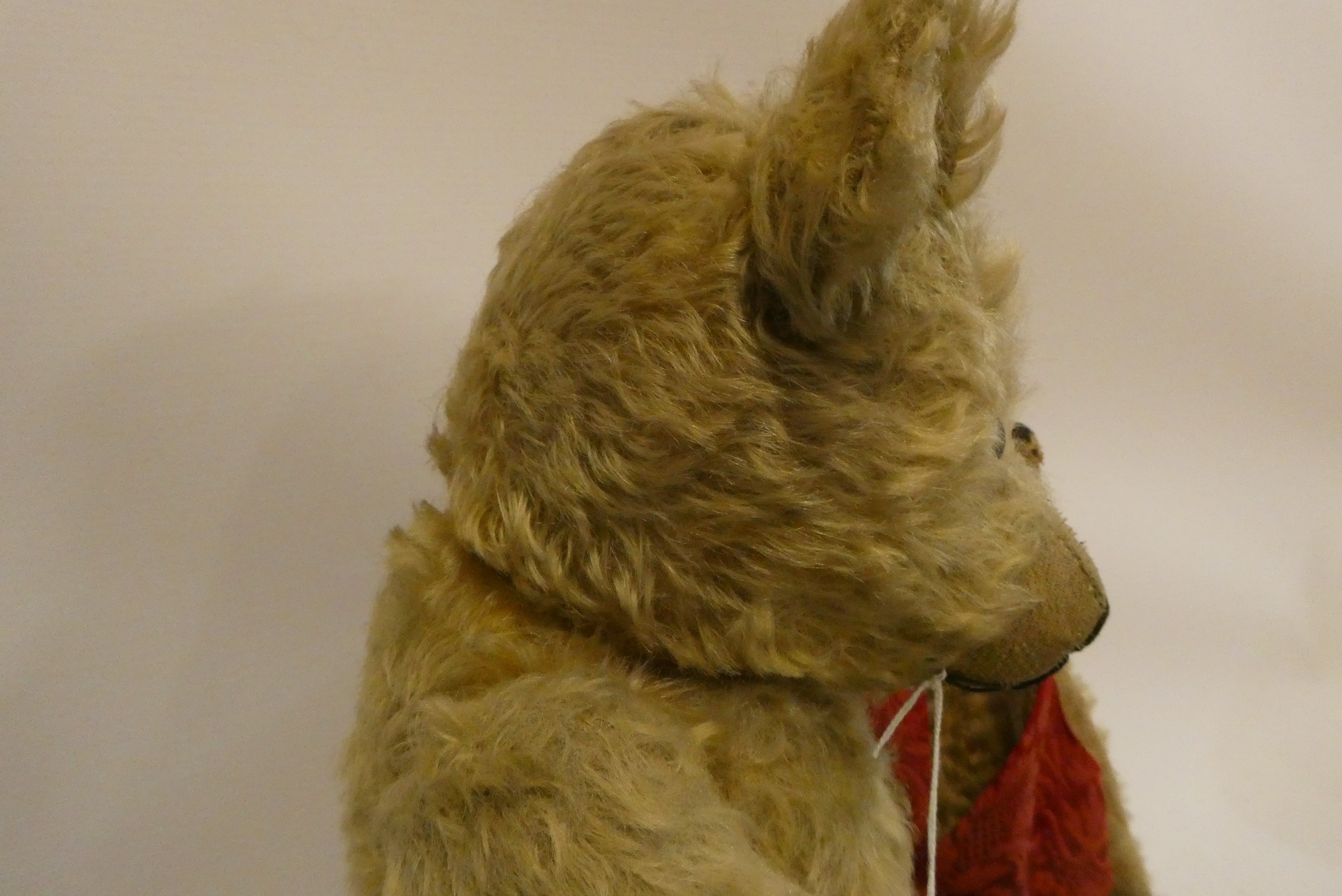 Two old straw filled teddies, comprising a 20" vintage English bear with shaven muzzle, amber eyes Image