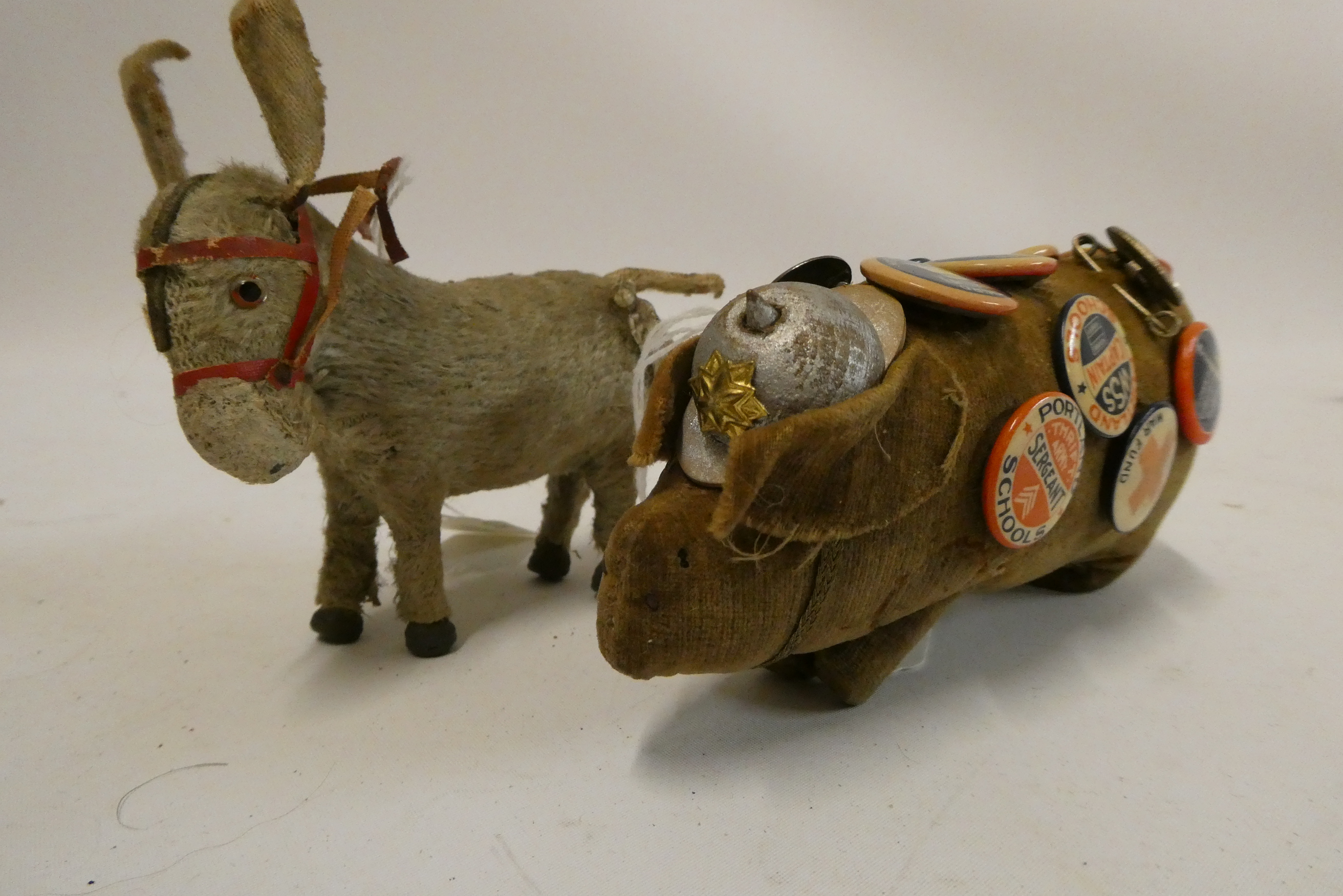 A 5 1/2" felt boar wearing a WWI style french helmet and covered in 16 badges including Portland Image
