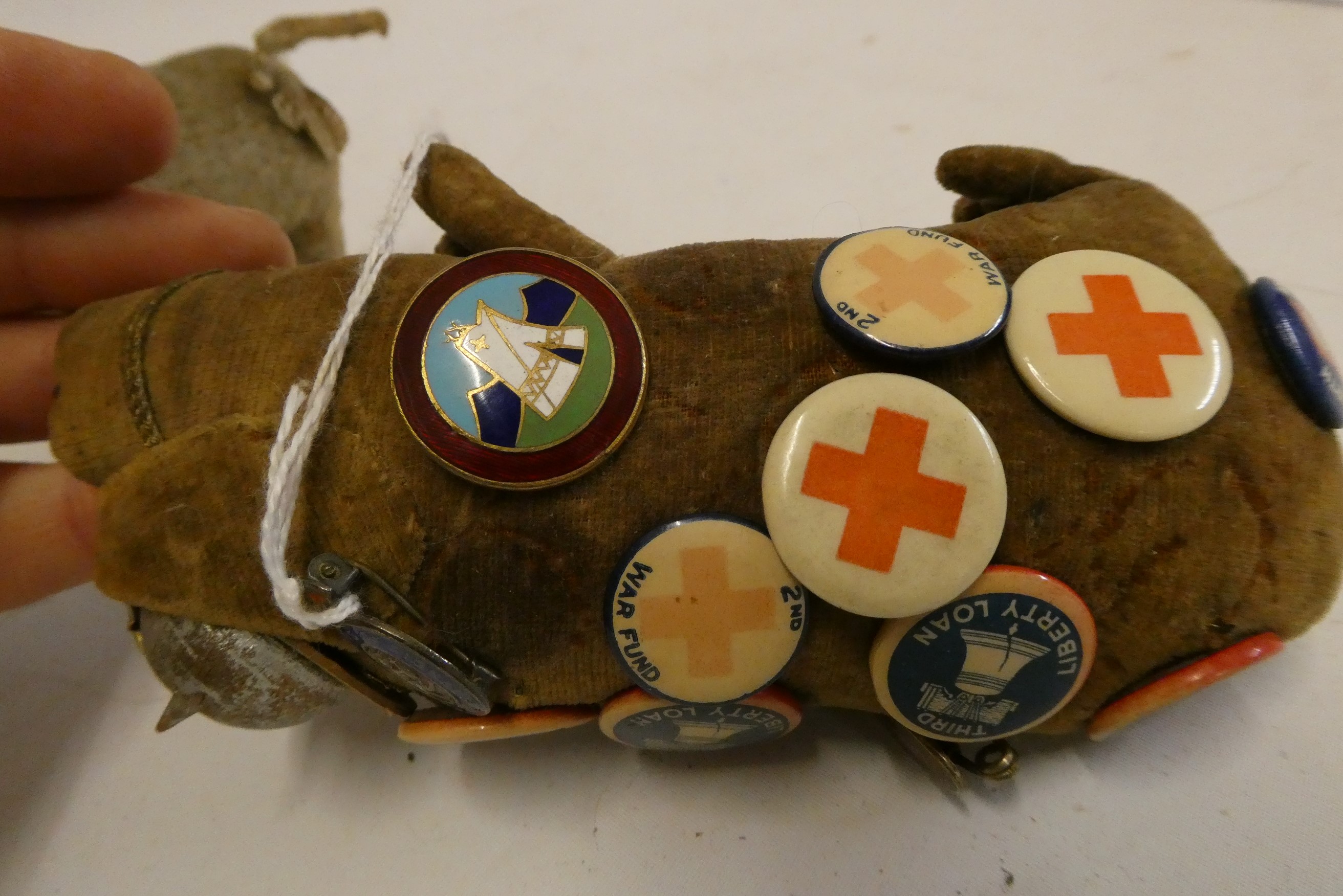 A 5 1/2" felt boar wearing a WWI style french helmet and covered in 16 badges including Portland Image