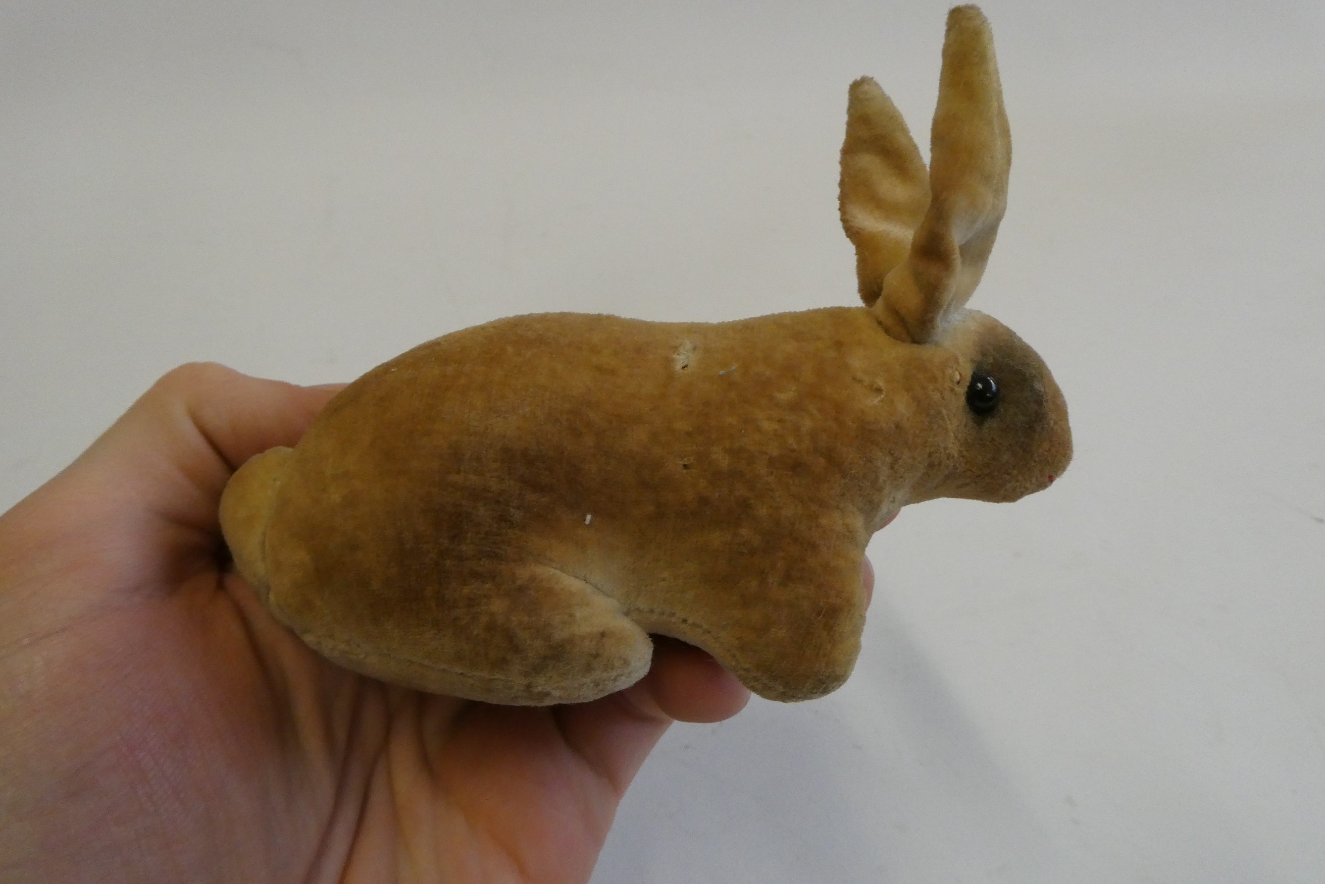 An early velvet rabbit, possibly Steiff, with shoe button eyes, 5" long Image