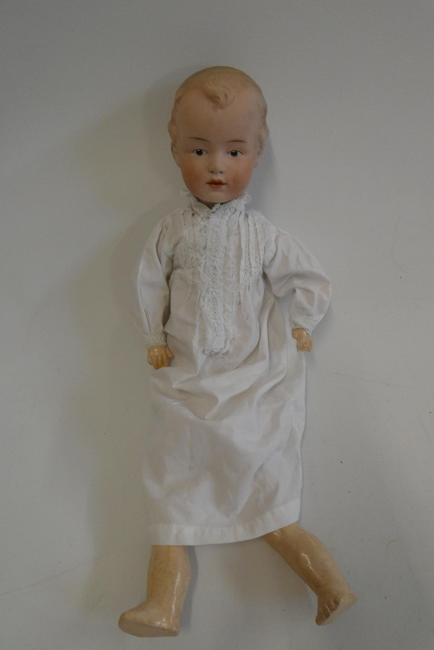 A Gebruder Heubach bisque socket head boy doll, with moulded eyes, moulded hair, closed mouth, wood Image